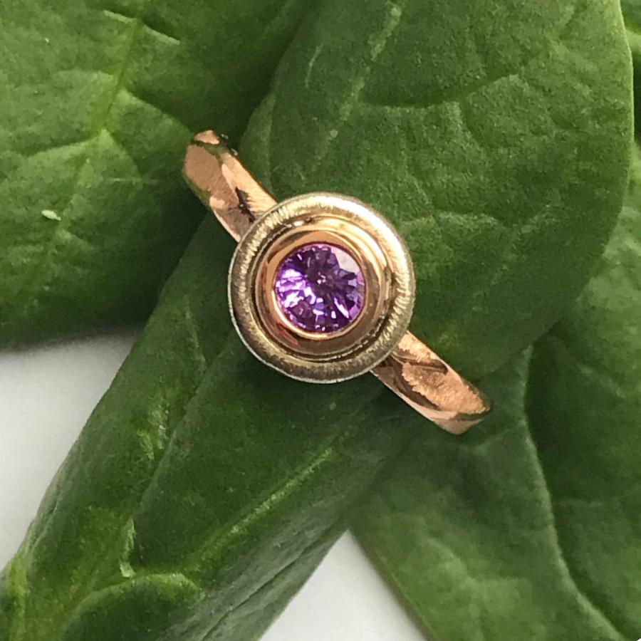 K.Mita’s Emma Ring is made from 18k Rose Gold and a 0.46ct Purple Sapphire set in 18k White Gold. The width of the shank is only 3.0mm, but around the stone setting it is 9.0mm wide. Please allow 10-14 days.  Available in US Sizes #4.0-7.0. Please