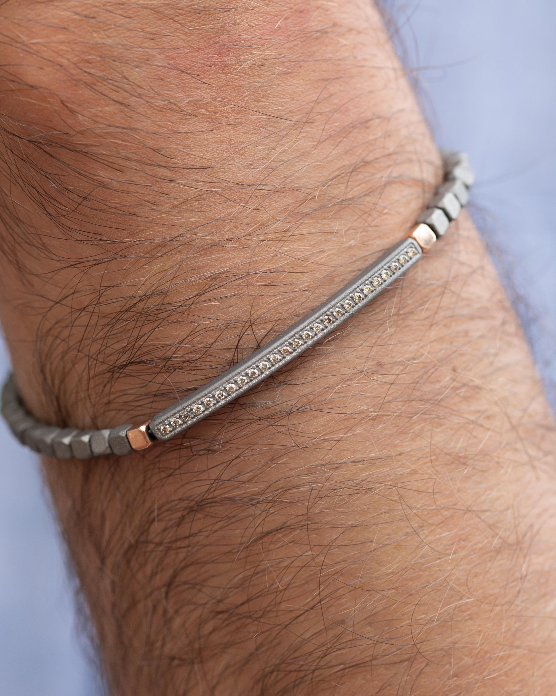 This titanium bracelet is from our Men's collection. Bracelet is decorated by 25 beautiful natural brown diamonds in total of 0.20 Carat and 18K rose gold details. The bracelet is 20 cm long. Perfect for daily wear!

The men’s collection is a