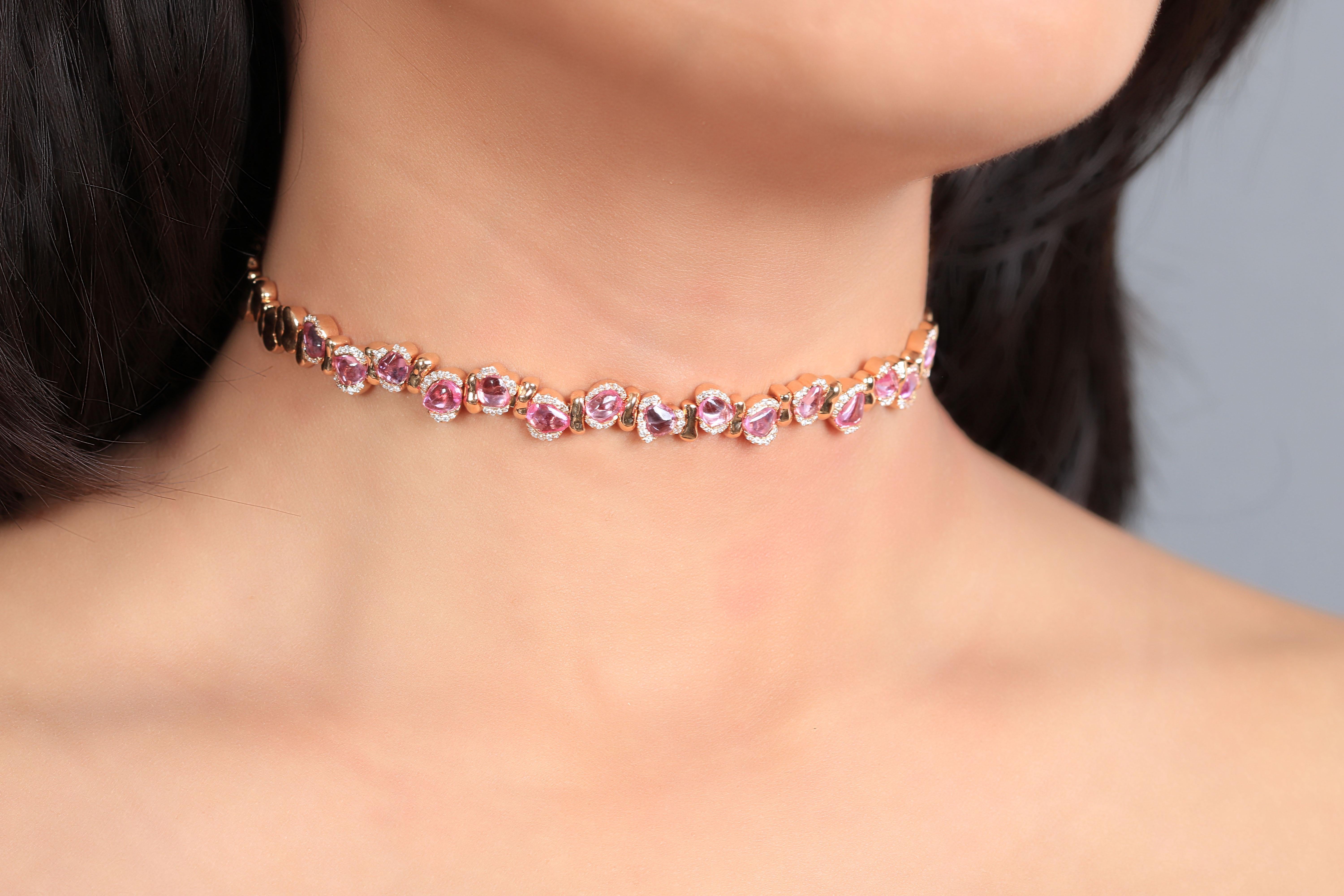 Designed with simplicity, this rose gold choker is adorned with pave white diamonds on the sides while tumbled pink sapphires appear elegantly in the middle. The gold in this choker is handcrafted around the stone rather than forcing it into
