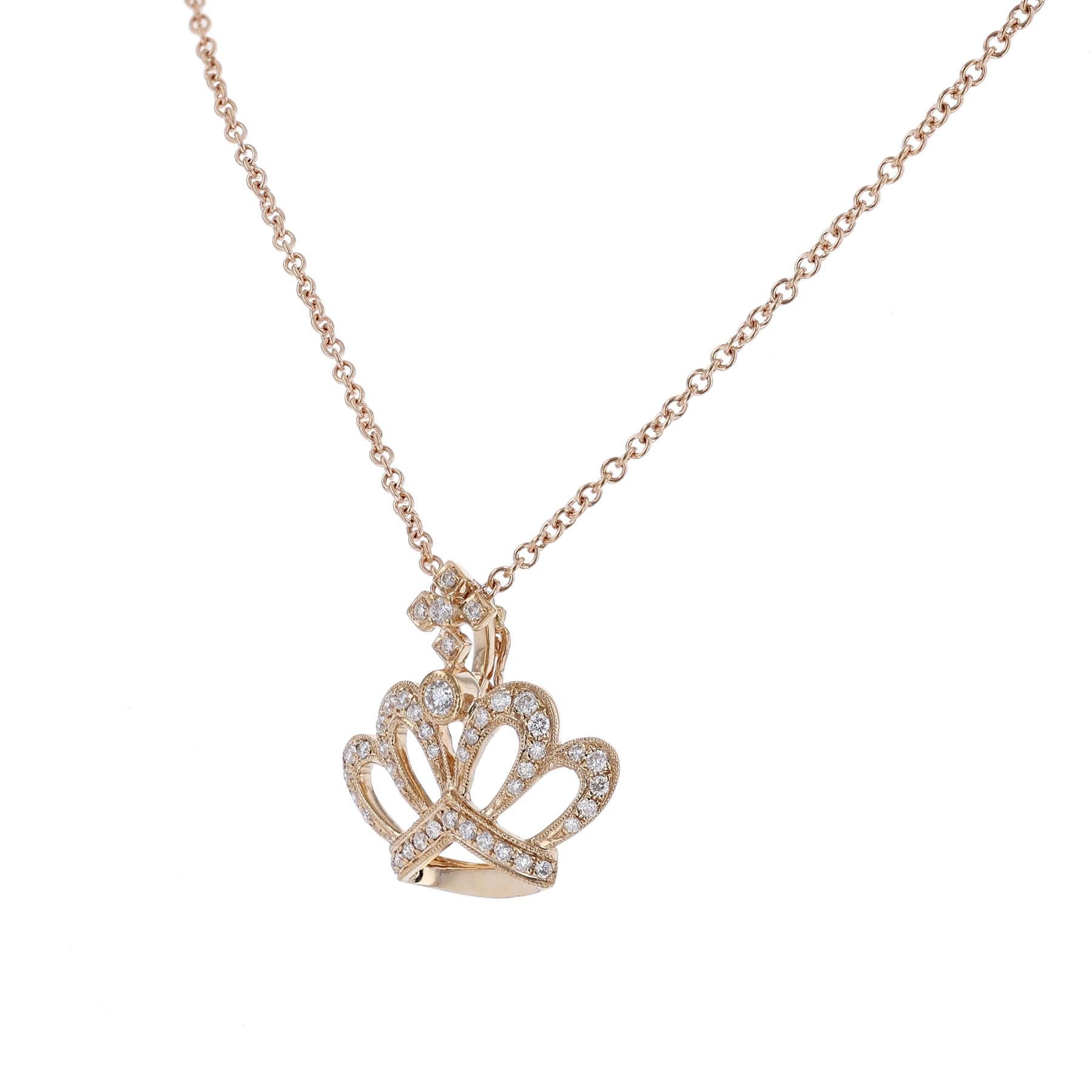 This pendant necklace is made in 18 Karat Rose Gold on a 14K Rose Gold chain. It features crown with a cross pendant of 45 round cut diamonds weighing 0.34 carats. The necklace has a color grade H and clarity grades SI2. 
