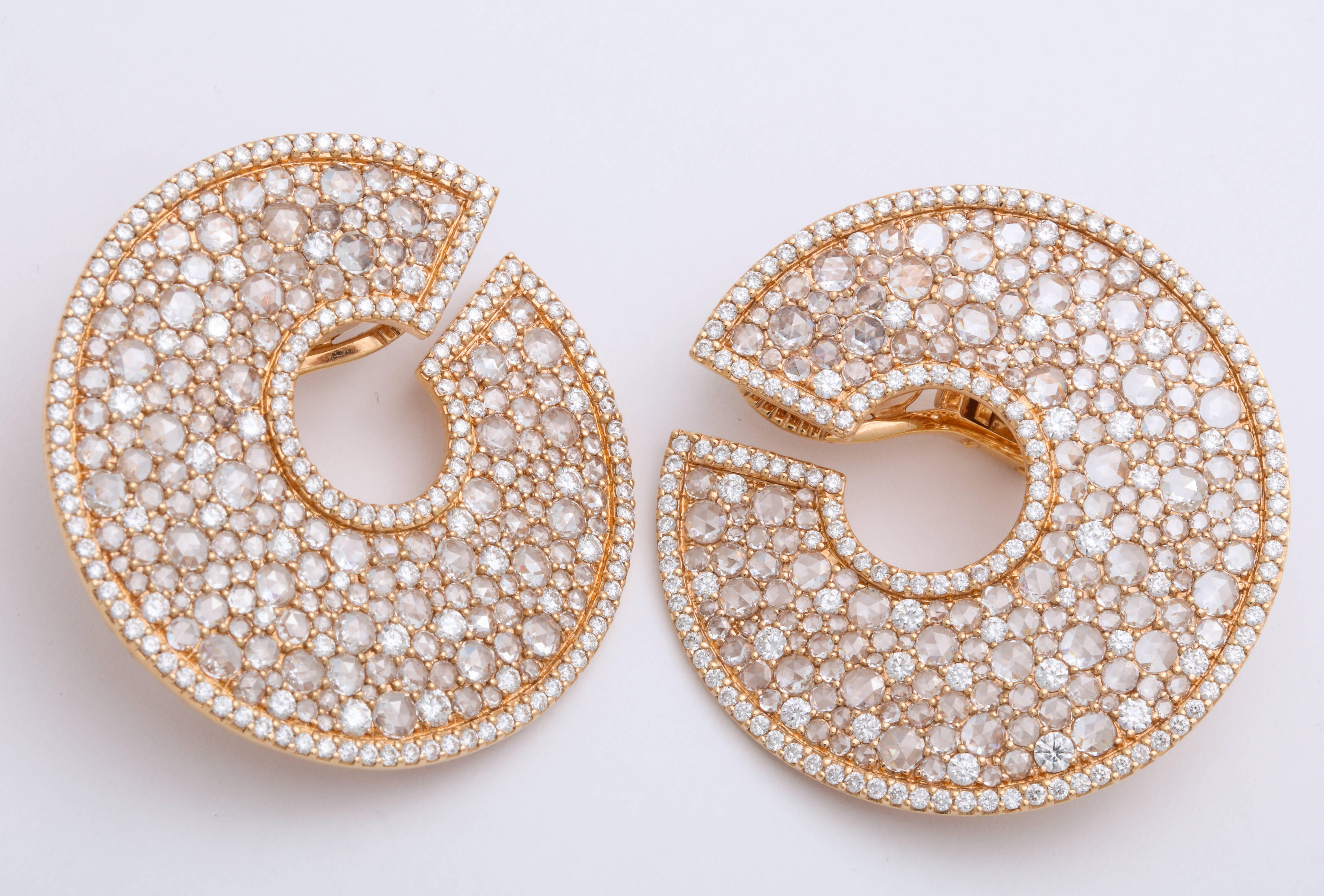 Bold, beautiful and bright stylized Art Deco inspired C-scroll earrings decorated with round rose-cut colorless diamonds: 9.62 carats, staggered with round brilliant-cut colorless diamonds: 4.57 carats, set in 18 Karat rose gold.  These beautiful 