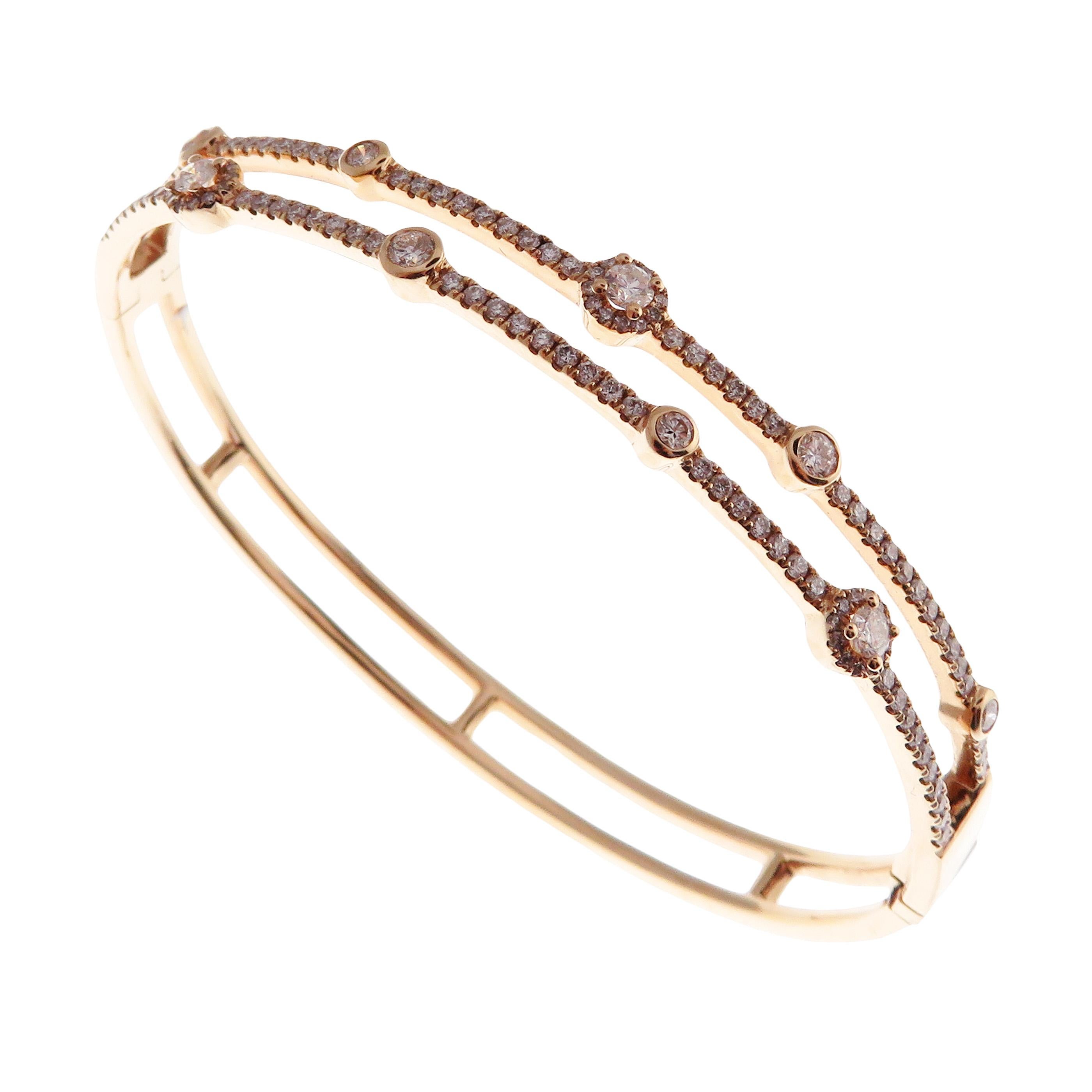 This double-row pave bangle is crafted in 18-karat rose gold, weighing approximately 1.19 total carats of SI-Quality white diamond. Side clasp closure.  

Fits wrists up to 6.50