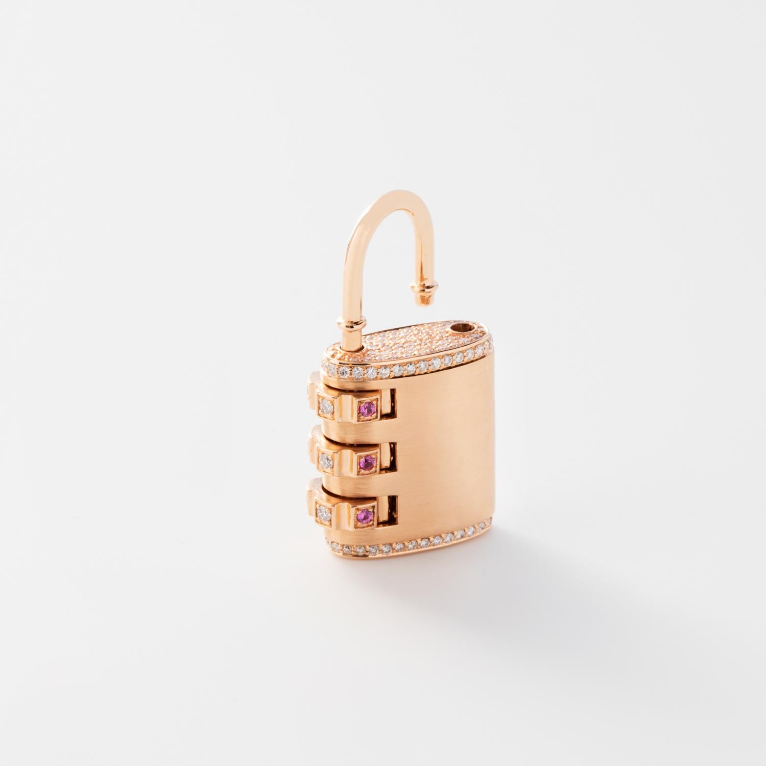 18k Padlock Pendant features a solid 18k Rose Gold pendant with pave White Diamonds throughout and white diamonds and pink sapphires on the dial, and a custom code that locks and unlocks the pendant. 
Lock Combination can be customized with any
