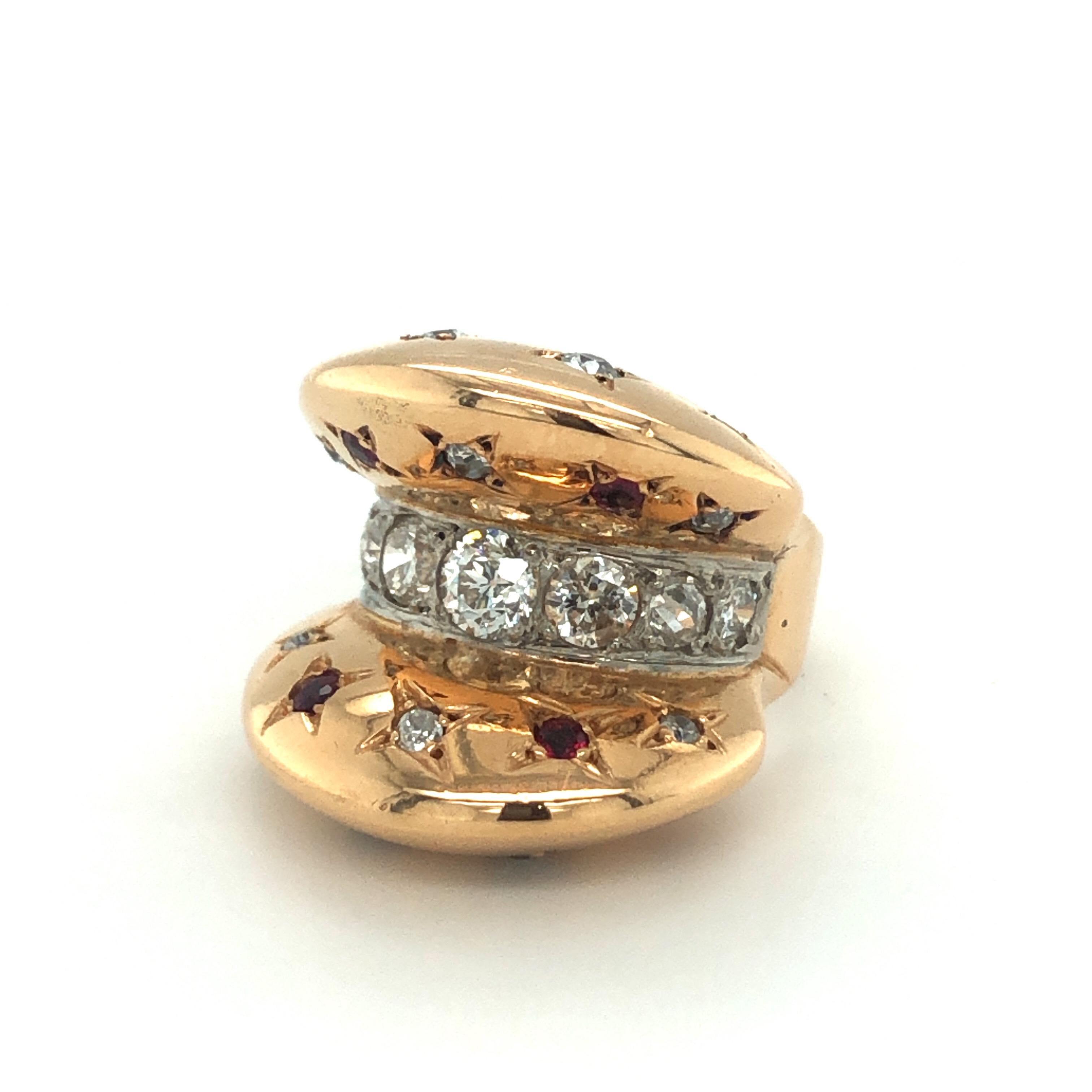 18 karat rose gold diamond and ruby retro ring, circa 1940.
A one-of-a-kind retro design ring, the central line set with graduated round old-cut diamonds totalling circa 0.9 carats and flanked by 2 halfmoon-shaped, arched endings enhanced with