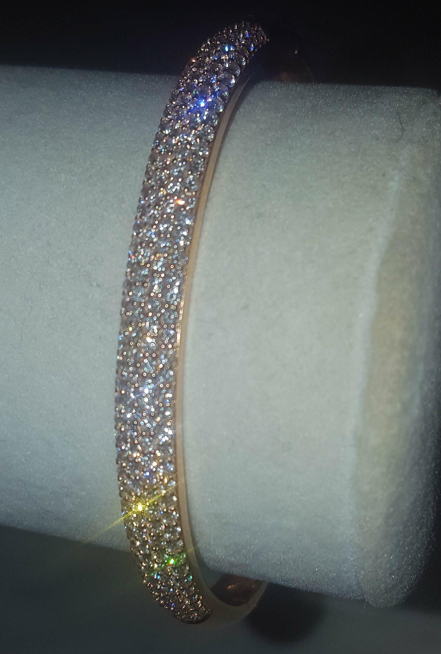 Brand new, never worn!  Crafted in 18 karat rose gold, this tapered bangle boasts a top section containing 172 round white diamonds, pave set, with a combined total weight of 2.32 carats.  The sparkle is eye popping!  A double 'click' hidden clasp
