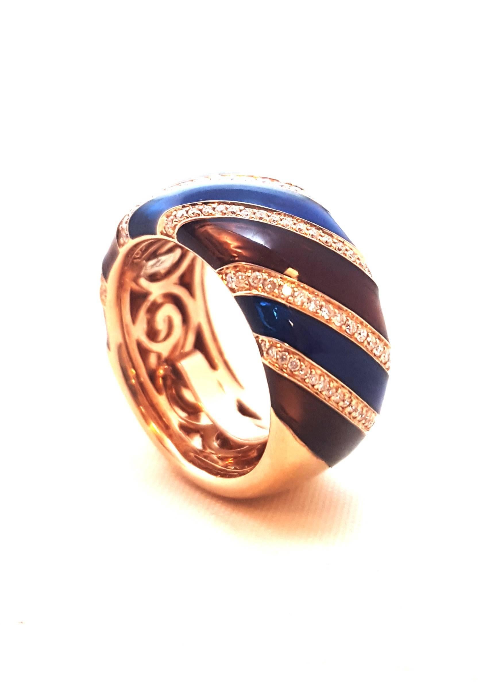 Unique, comfortable and oh, so beautiful!  This 18 karat rose gold band style ring is a festival of color!  The rose color lends itself perfectly to gracefully curved sections of cobalt blue and maroon enamel inserts.  Each insert is separated by a