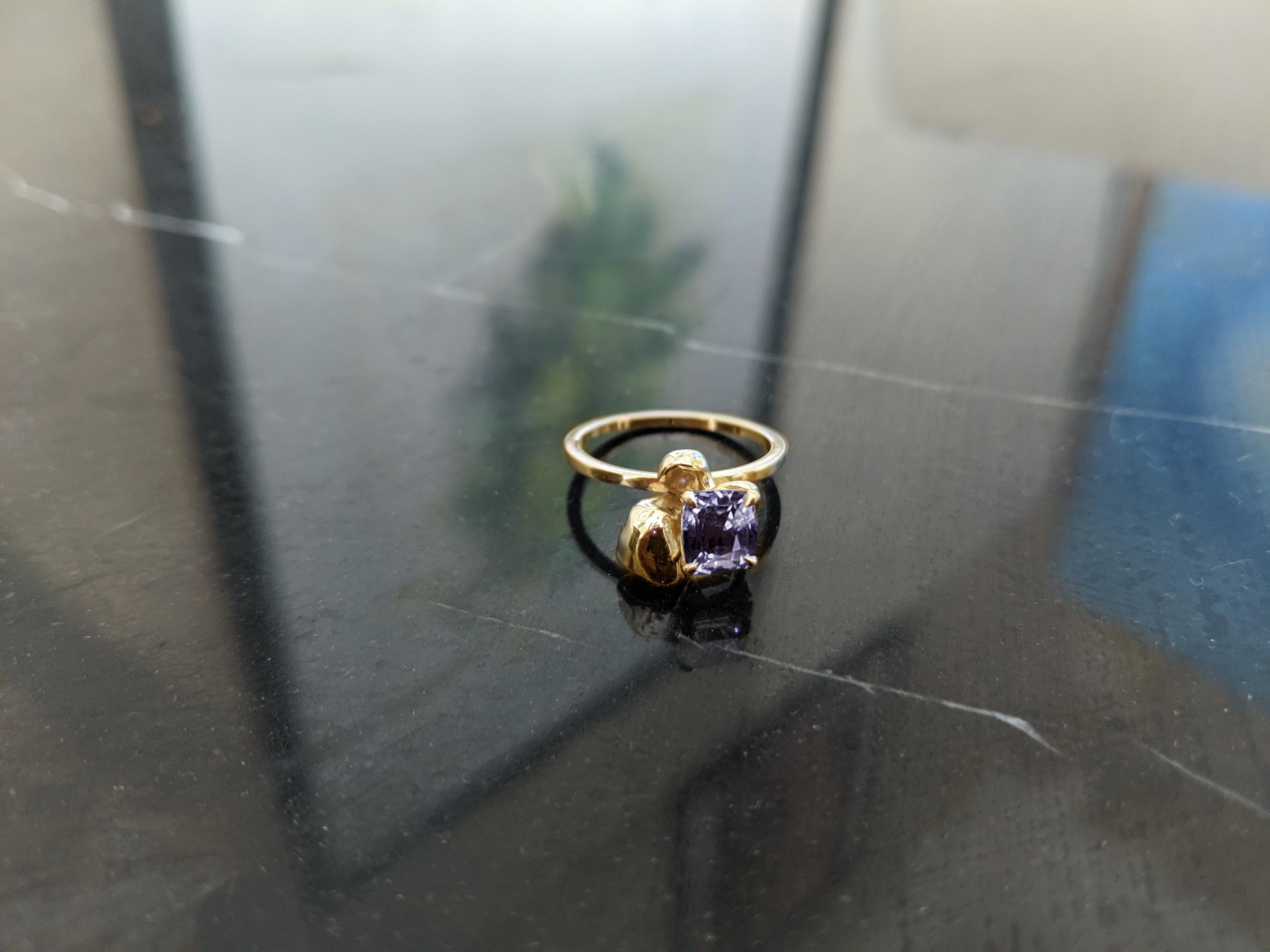 This Buttercup Flower contemporary ring is a beautiful piece of jewelry, crafted from 18 karat rose gold and encrusted with a natural cushion purple spinel, weighing 1.34 carats. The ring is designed by the oil painter from Berlin, Polya