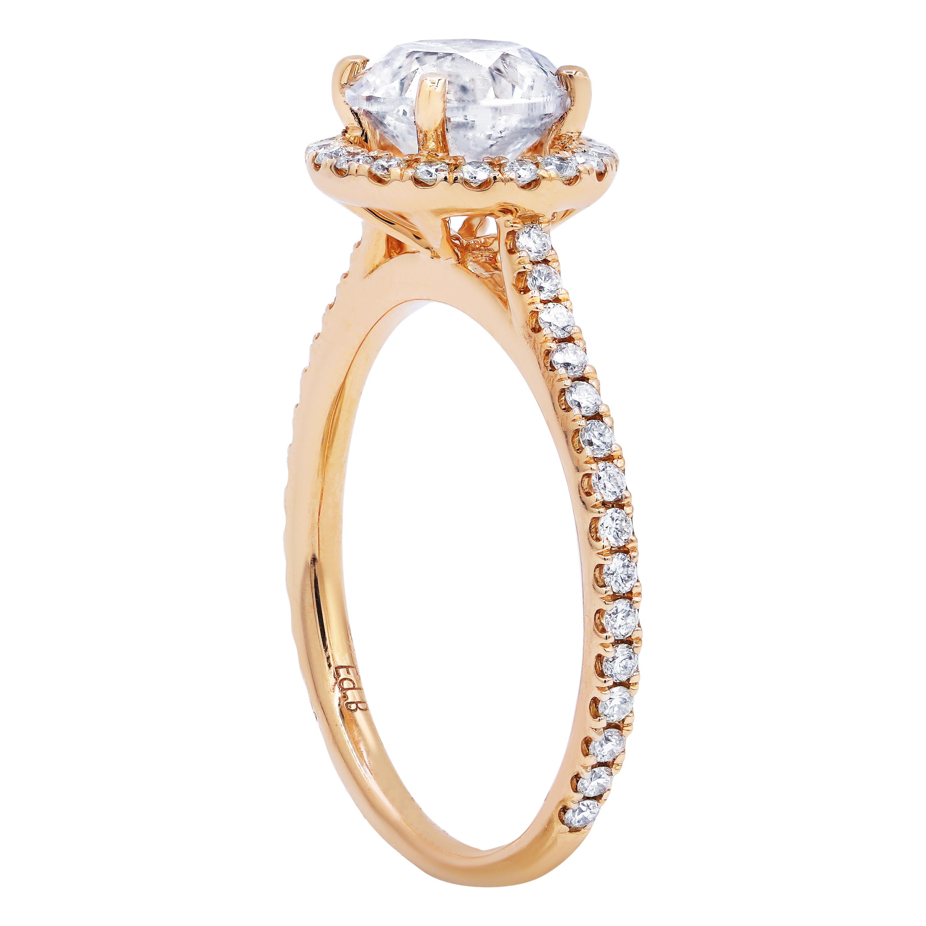 18 karat rose gold halo diamond engagement ring features 1.55 carat clarity enhanced round cut diamond set with additional 0.38 cts round diamonds on the side.
