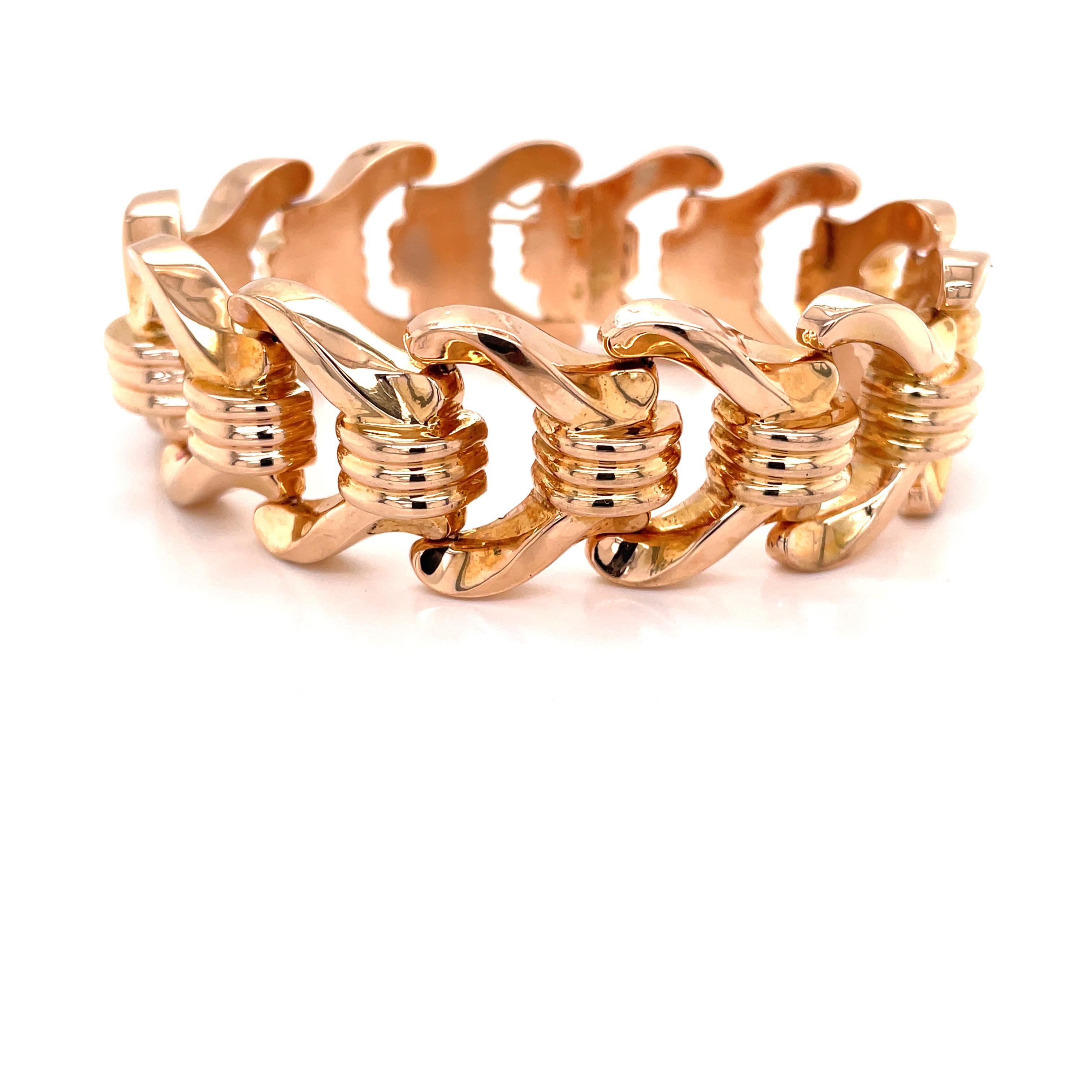 Brightly polished stylish links of eighteen karat 18K rose gold create this spectacular retro bracelet. Quality Italian made, thirteen blush color 18K gold hollow links, each measuring approximately 7/8 inch wide, keep this bold statement piece