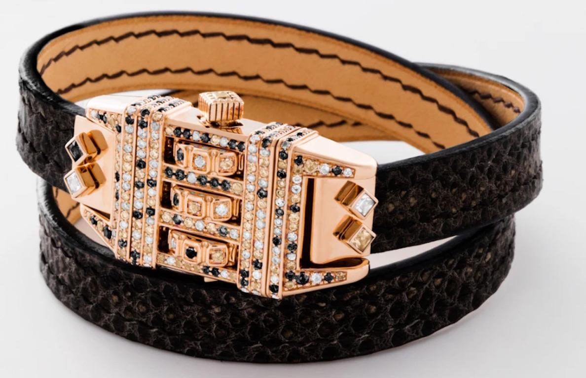 18 Karat Leather Wrap Code Bracelet features a solid 18k Rose Gold bracelet with pave white diamonds, black diamonds and champagne diamonds on the face with a custom code that opens and locks the bracelet onto the wearer's wrist, and completed with