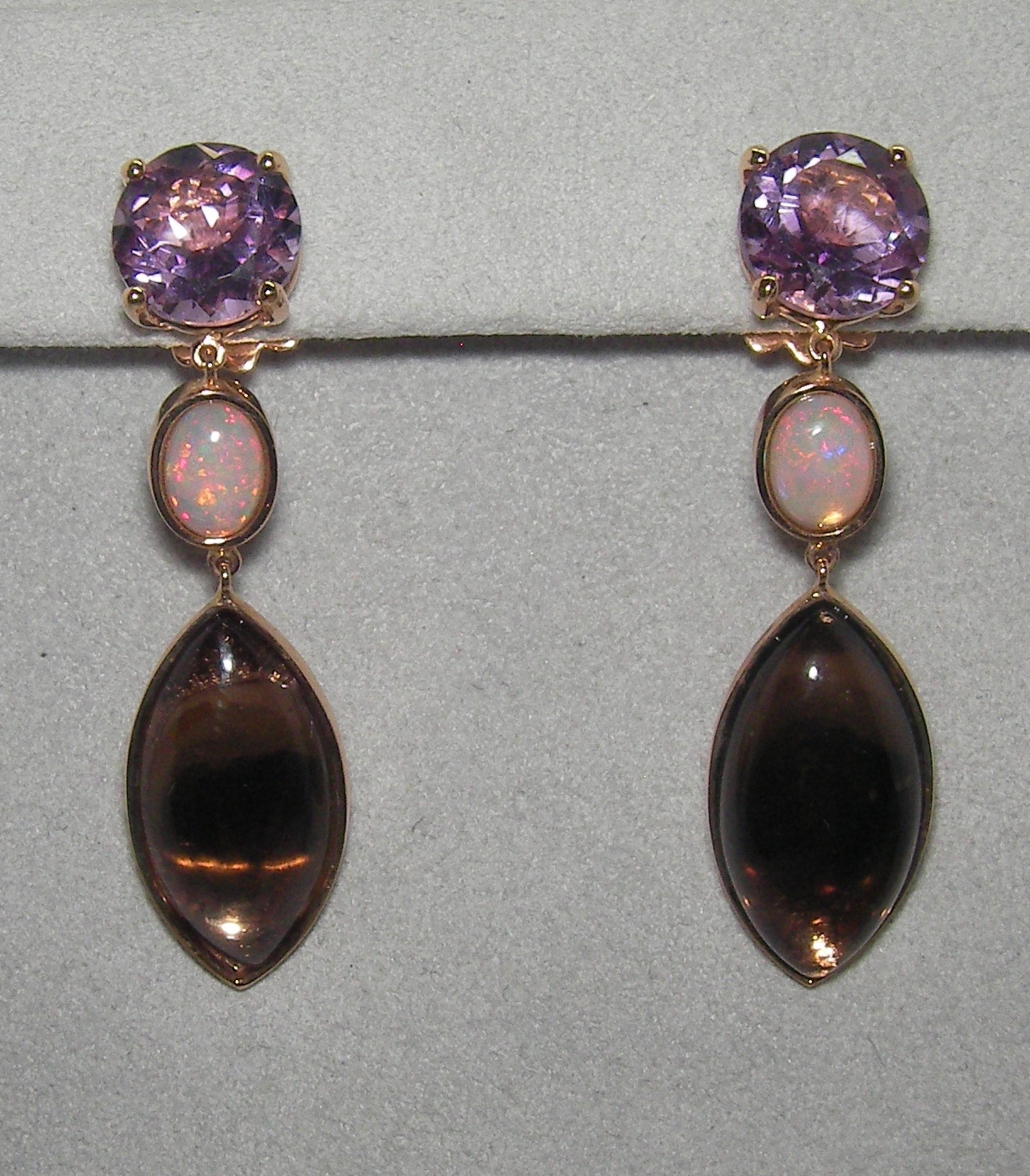 These elegant 18 Karat Rose Gold Dangle Earrings exude elegance and sophistication. The base of each earring consists of a vivid round briolette cut Amethyst, followed by an oval cabochon cut Opal and finished with a beautiful marquise cabochon cut
