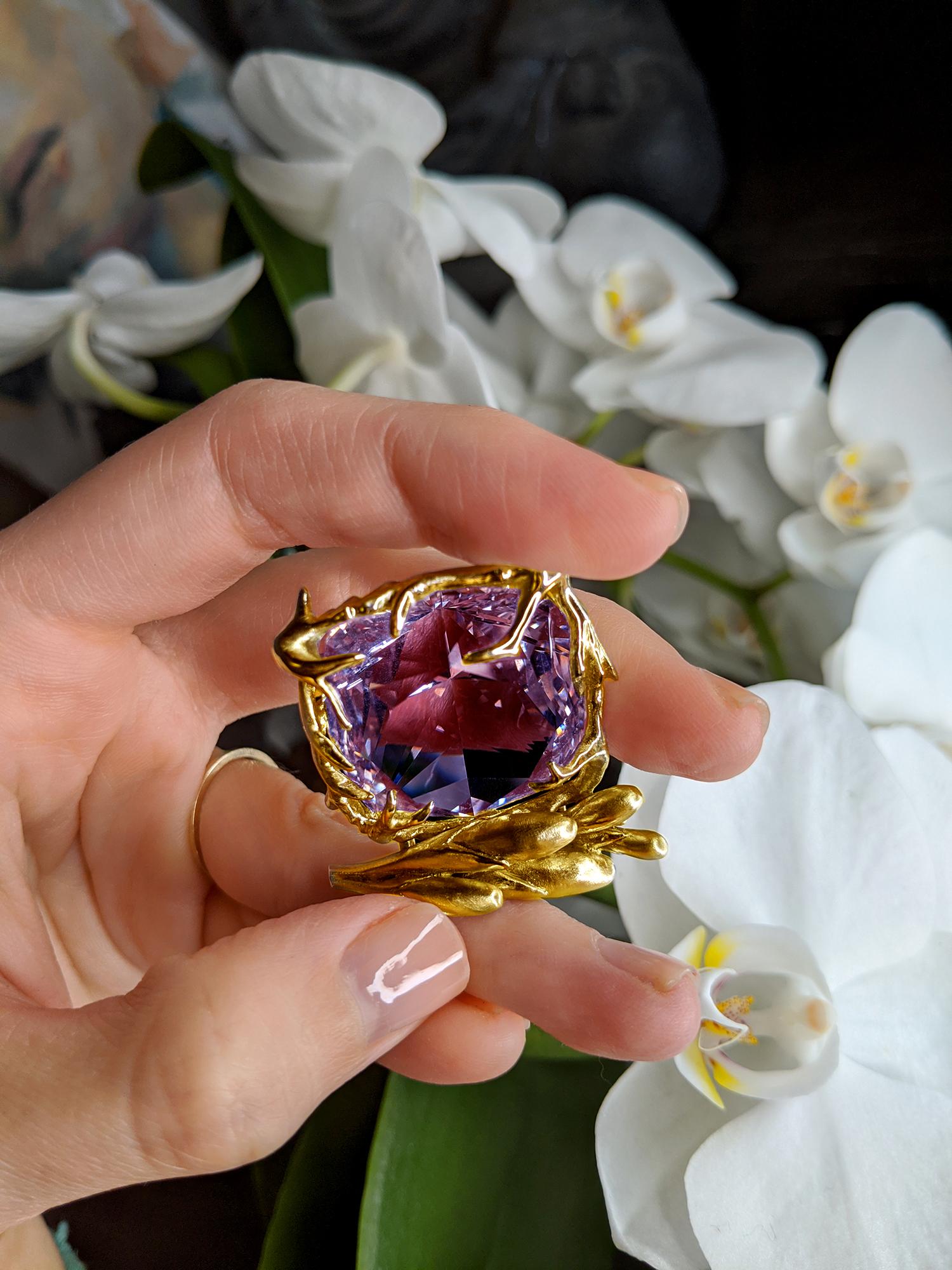 This Fairy Tale pendant necklace is a contemporary masterpiece designed by oil painter Polya Medvedeva. It is crafted from 18 karat yellow gold and features an antique cushion-cut amethyst that radiates vivid tones. The pendant is adorned with