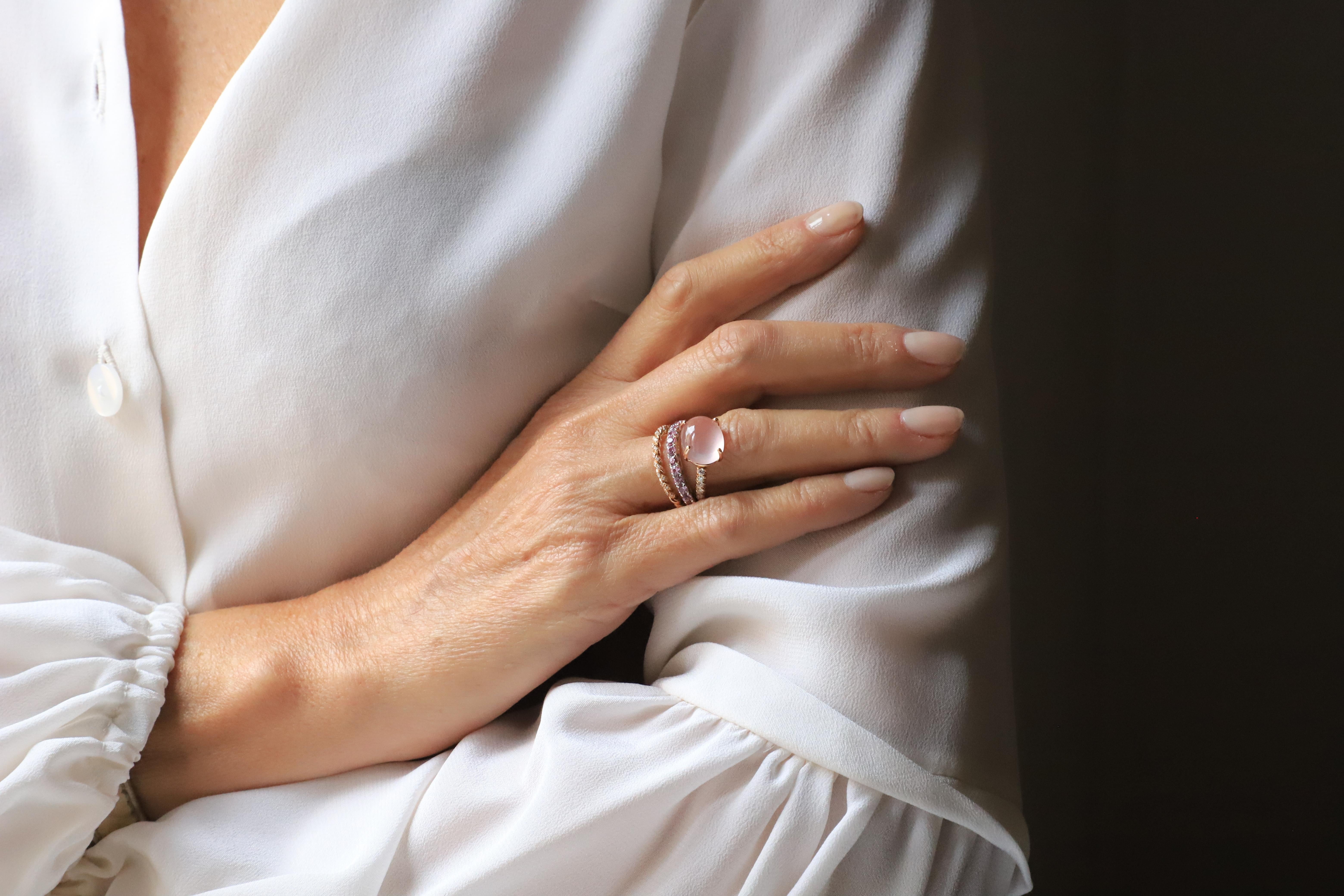 Rossella Ugolini Design Collection  Modern style ring handcrafted in 18 Karat Rose Gold with 3 Carat Rose Sapphires, Pink Cabochon oval cut Rose Quartz and  0.10 Karat White Diamonds.
A timeless linear ring, different from all other design, made of