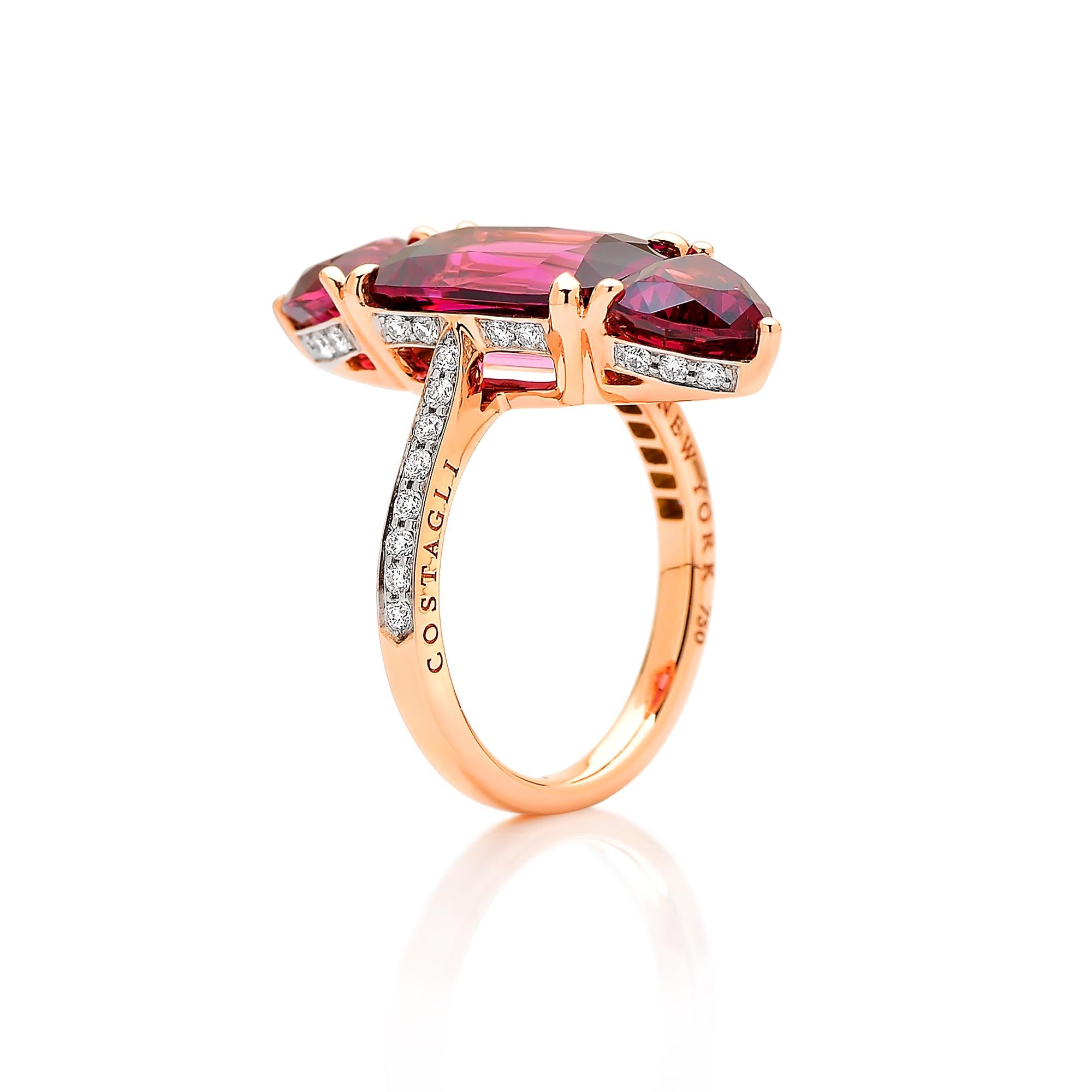 One of a kind emerald cut rhodolite garnet ring flanked by trillion shape rhodolite garnets set in 18kt rose gold with pave-set round, brilliant diamond detailing.

Clean lines, warm colored natural gemstones, and ideal cutting make this rhodolite