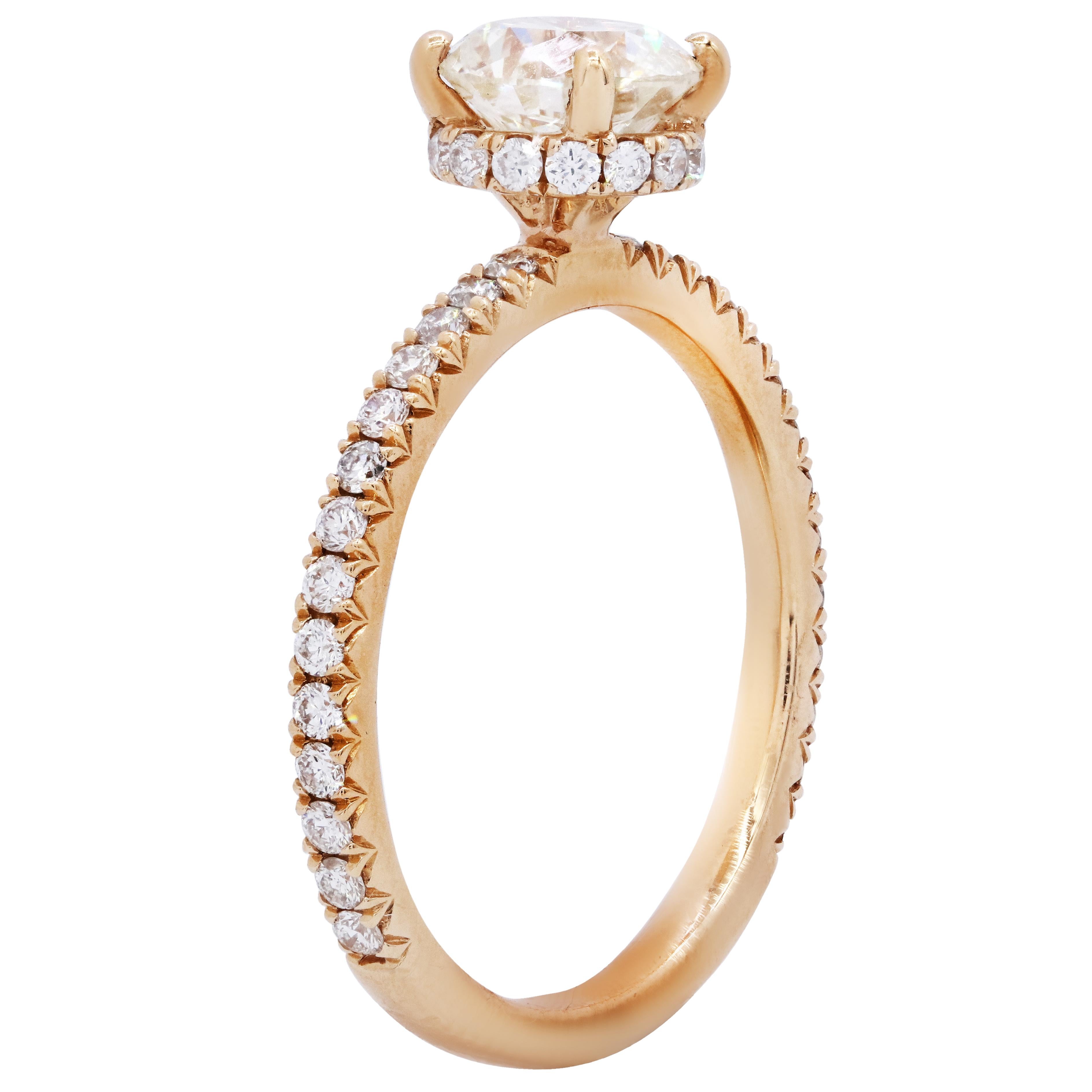 18 karat rose gold diamond ring features 1.20carat round cut diamond in the center and surrounded by 0.50ct diamonds on the side 
