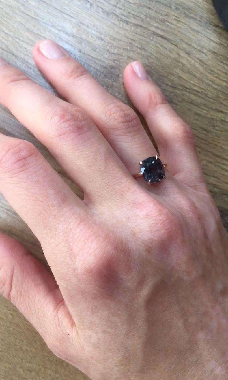 This exquisite ring features a 4.8 carat cushion-cut dark storm purple spinel from Tanzania, set in 18 karat rose gold. The size of the ring can be adjusted to fit your finger perfectly.

If you prefer a different gold color or spinel shade, this