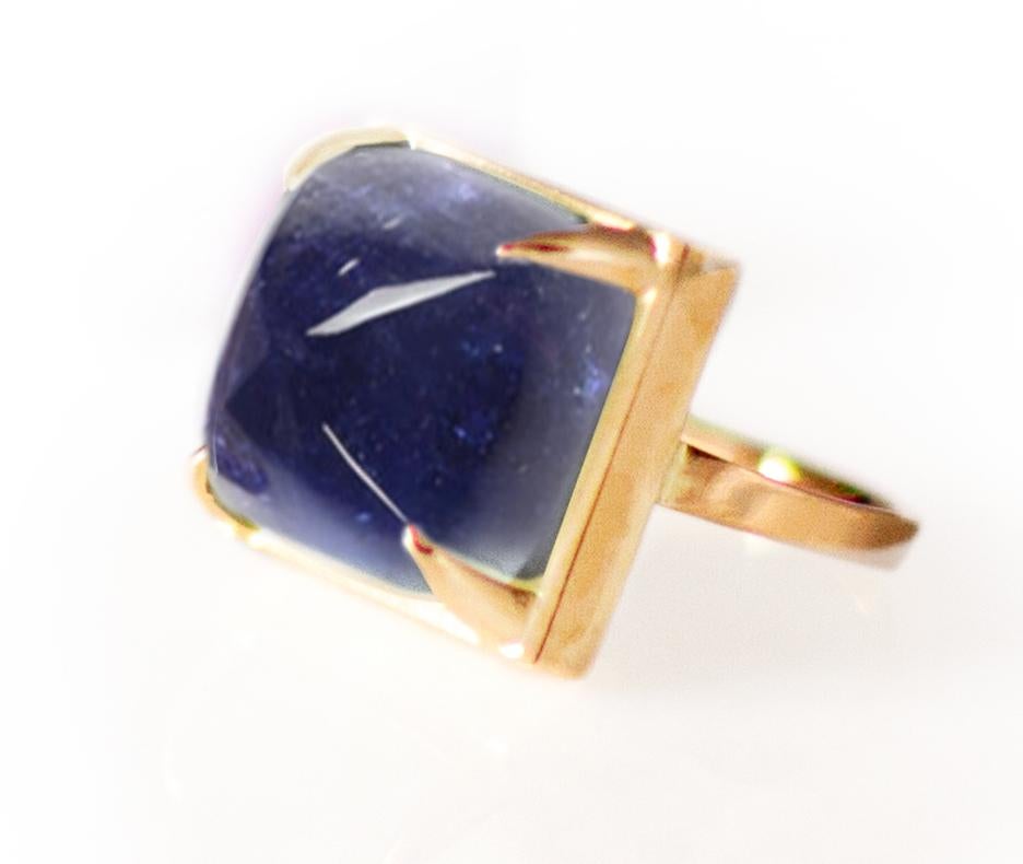 This ring is made of 18 karat rose gold and sugarloaf Iolite (8x8 mm, 0,3x0,3 inches, smaller than on some of the pictures).

When for most of the gem it works the way: the smaller prongs the better. This is the shape and size of the gem that we