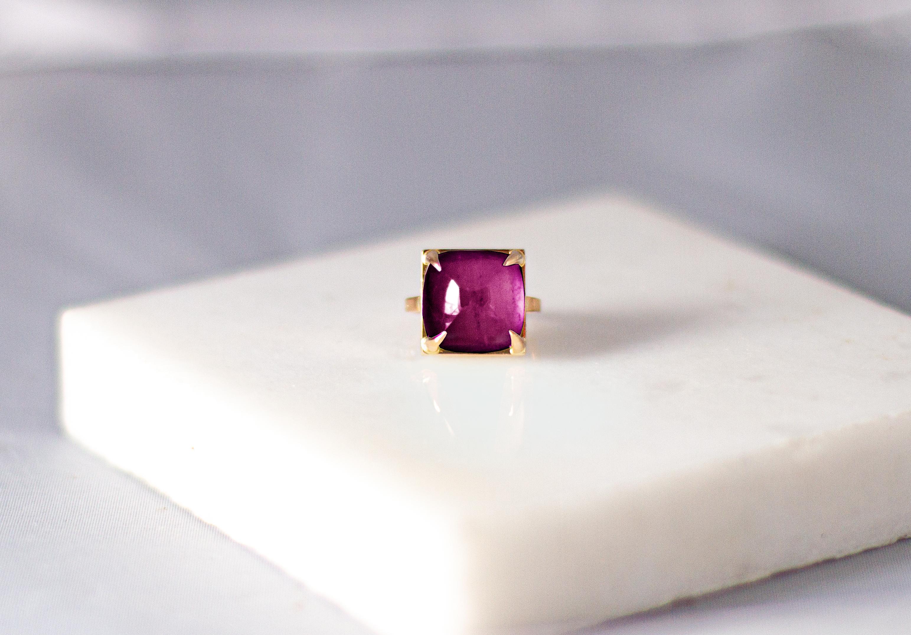 This engagement ring is made of 18 karat rose gold and sugarloaf natural pink tourmaline (14,7 mm/ 0,55 inches). 

When for most of the gem it works the way: the smaller prongs the better. This is the shape and size of the gem that we really enjoy