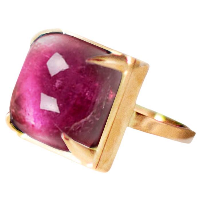 This ring is made of 18 karat rose gold and sugarloaf natural tourmaline (7,76 carats, 10,5 mm/ 0,6 inches). 

When for most of the gem it works the way: the smaller prongs the better. This is the shape and size of the gem that we really enjoy to