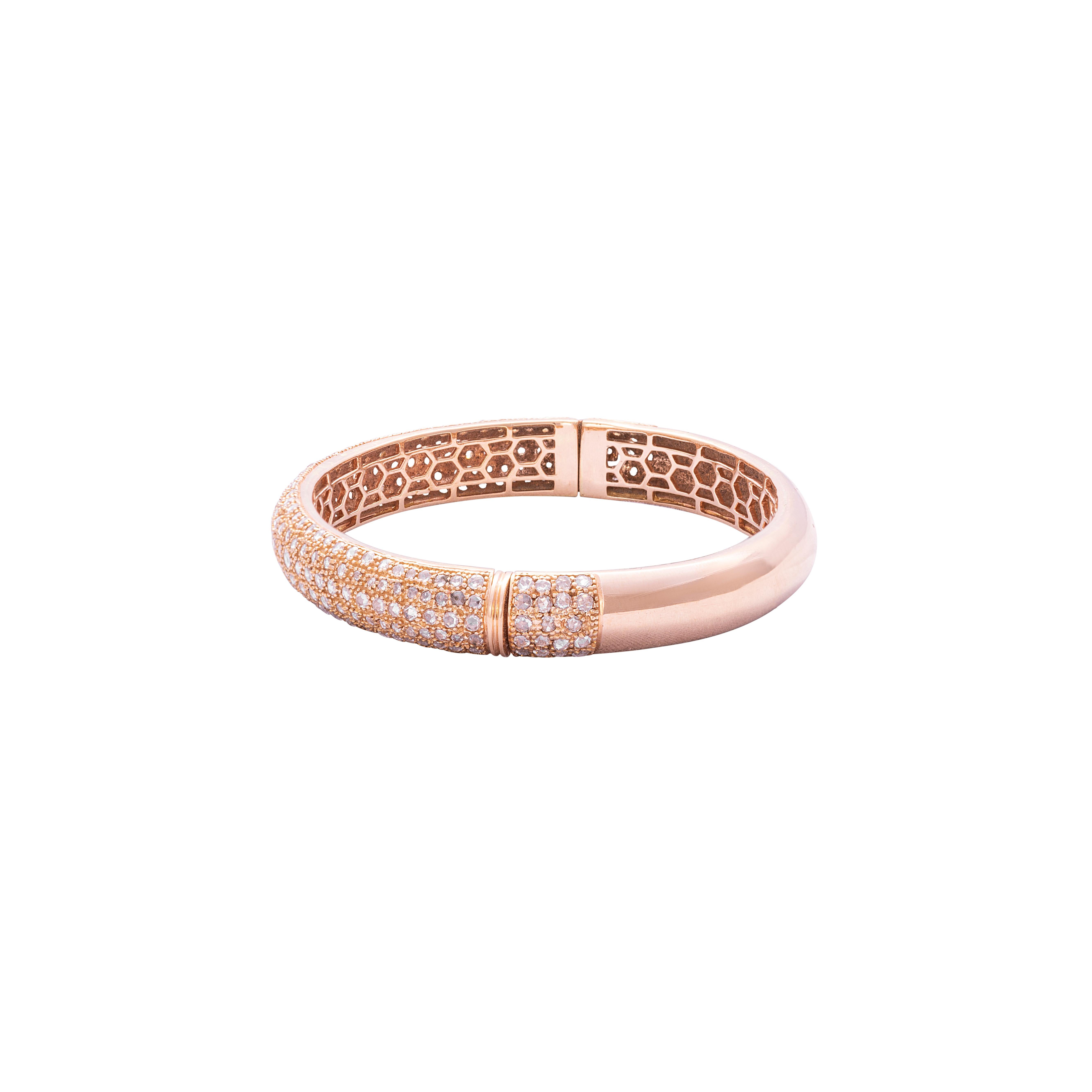 18 Karat Rose Gold Rosecut Diamond Cuff Bracelet

Beautifully crafted cuff bracelet, set in 18 Karat Rose gold studded with rosecut diamonds. The honeycomb design on the inside is indicative of the workmanship and design that sets this bracelet
