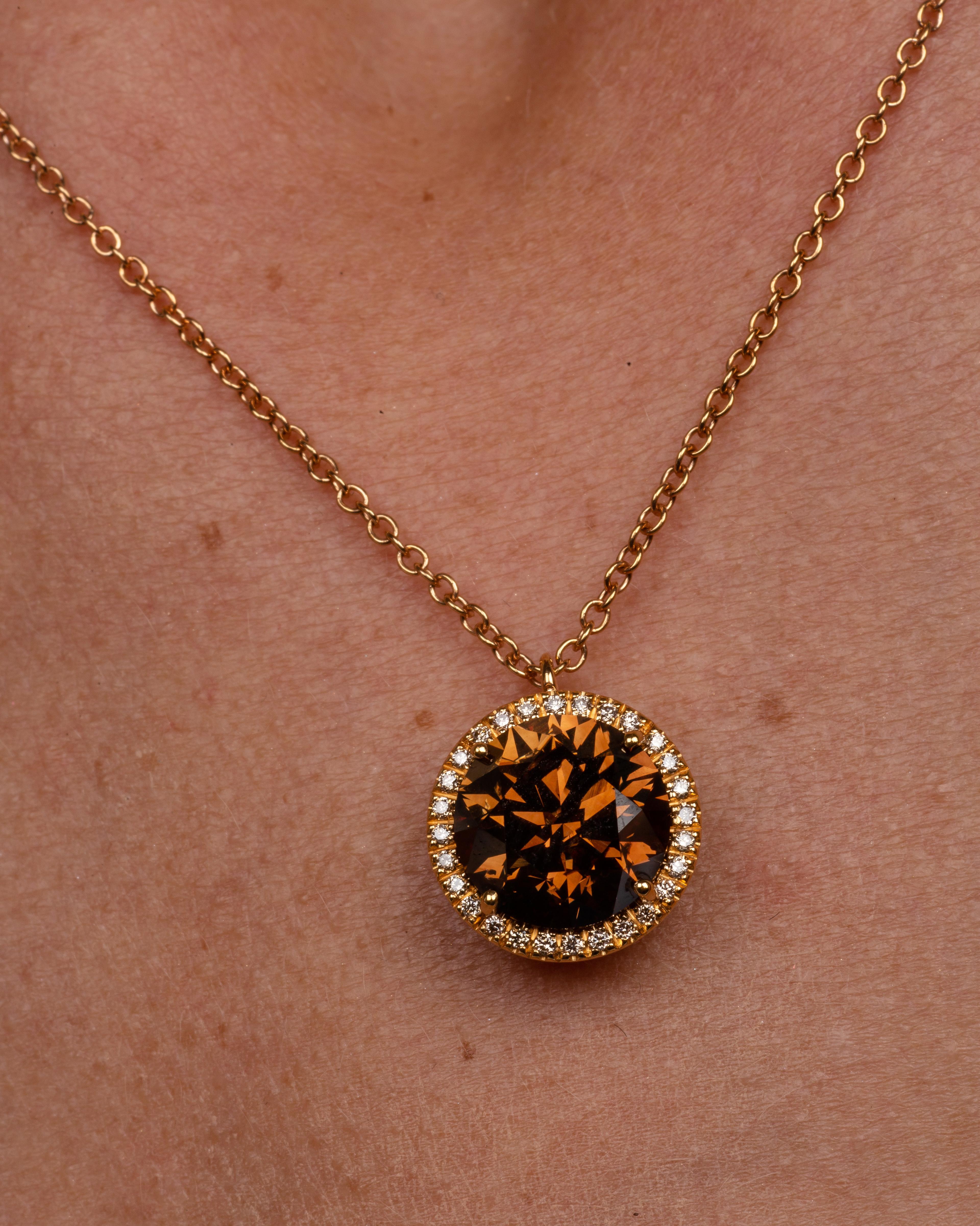 This 18K rose gold elegant pendant is from our Divine Collection. It is made of a round brown diamond in total of 5.01 Carat which is decorated by round brown diamonds in total of 0.14 Carat and round colorless diamonds in total of 0.12 Carat. Total