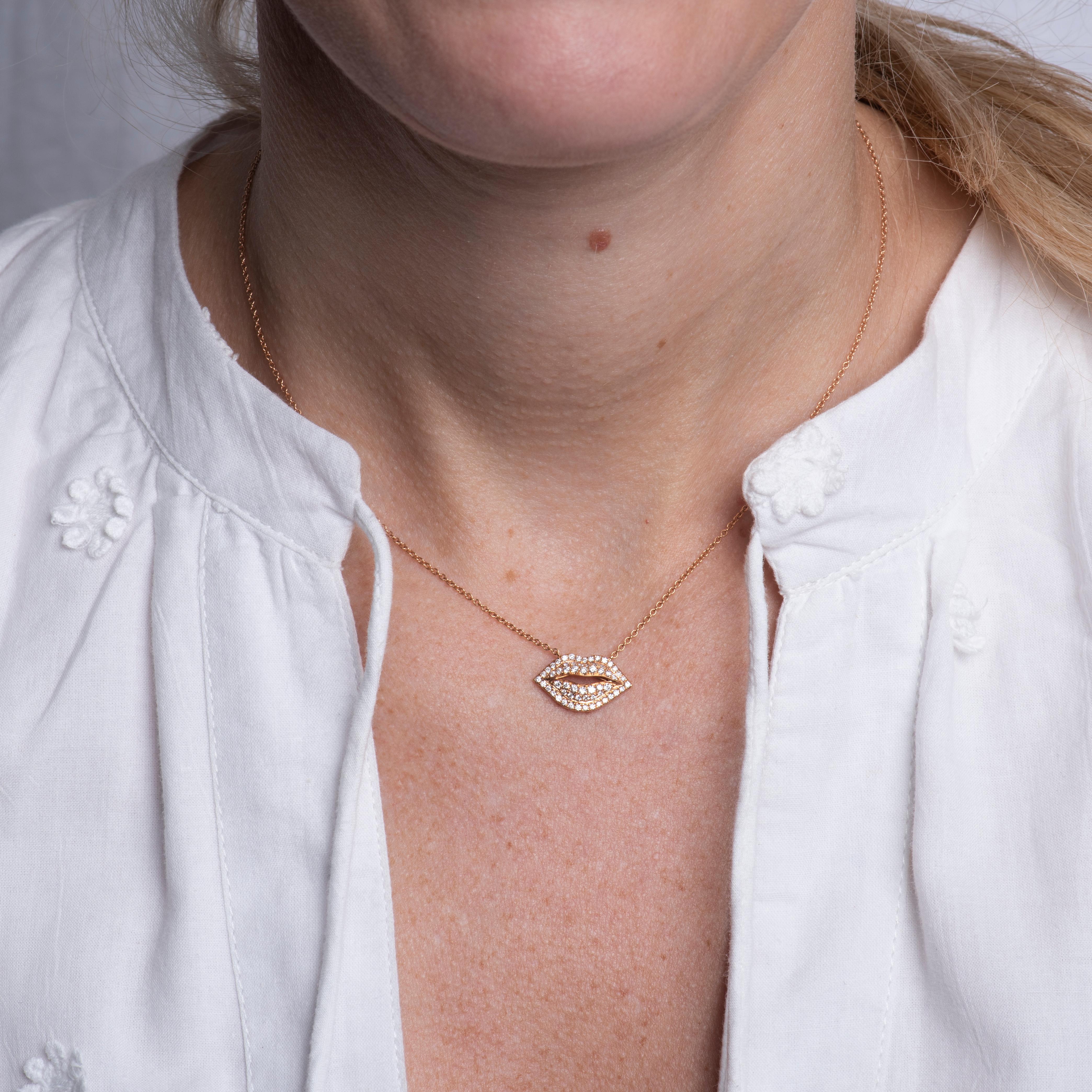 This unique pendant necklace features a set of lips set with 0.35 carat total weight in round diamonds. It is set in 18 karat rose gold on an 18 karat rose gold adjustable chain. Lobster clasp closure. Wear alone or layer with other necklaces for