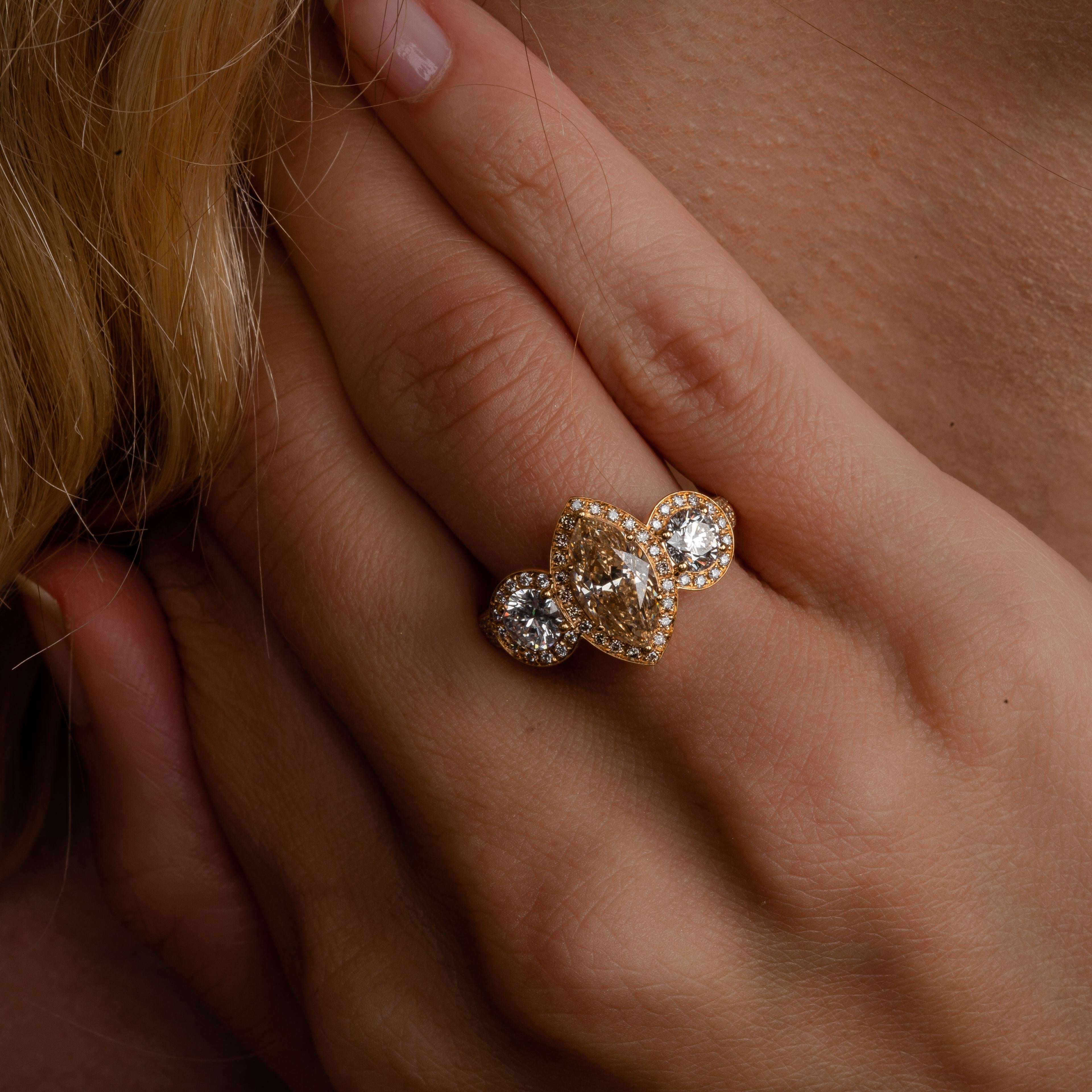 This 18K rose gold elegant cocktail ring is from our Divine Collection. It is made of a 3 stones,  marquise shape brown diamond in total of 2.06 Carat and 2 round shape colorless diamonds in total of 0.50 Carat each. All 3 diamonds are decorated by