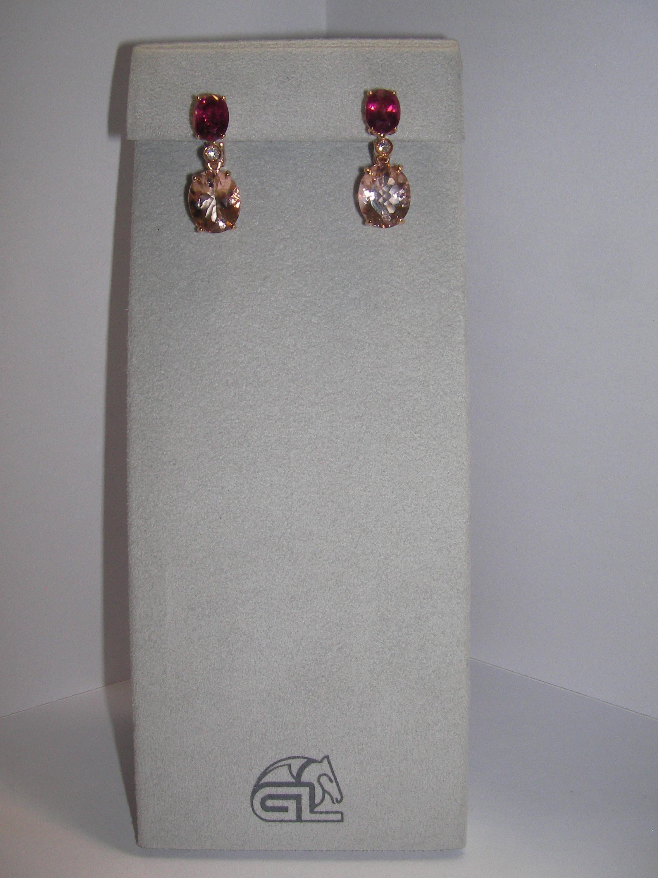 Classy set of earrings featuring a tourmaline base followed by a morganite stone. Both main stones are in oval cut and separated by a single diamond each. 

2 Diamonds 0.07 Carat 
2 Tourmaline 2.96 Carat 
2 Morganite 6.28 Carat