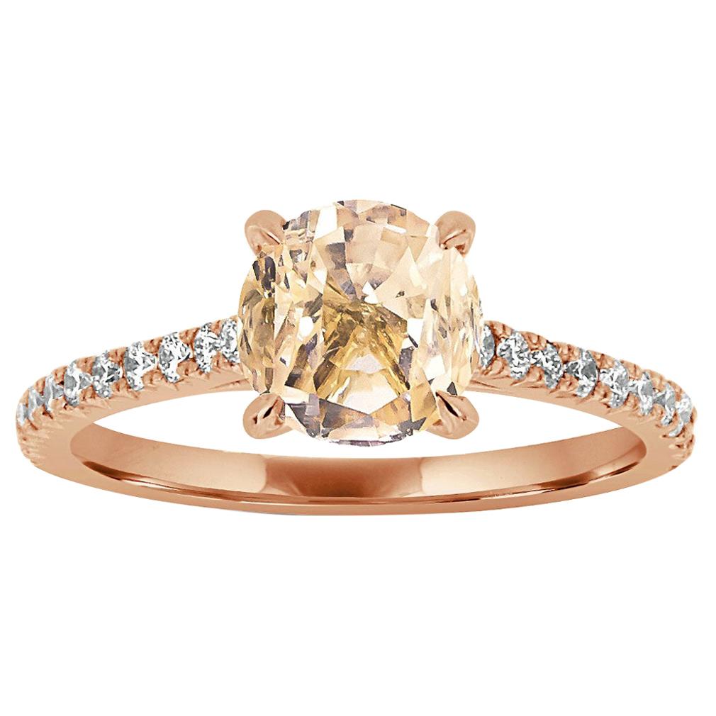 This classic ring features French Pave set diamonds in three-fourths of the band centering a 1.47 carat round Unheated Peach color Sri -Lankan Sapphire. Twenty-two brilliant round diamonds in weight of 0.25 Carat. The ring is 1.6 MM wide and 1.7 MM
