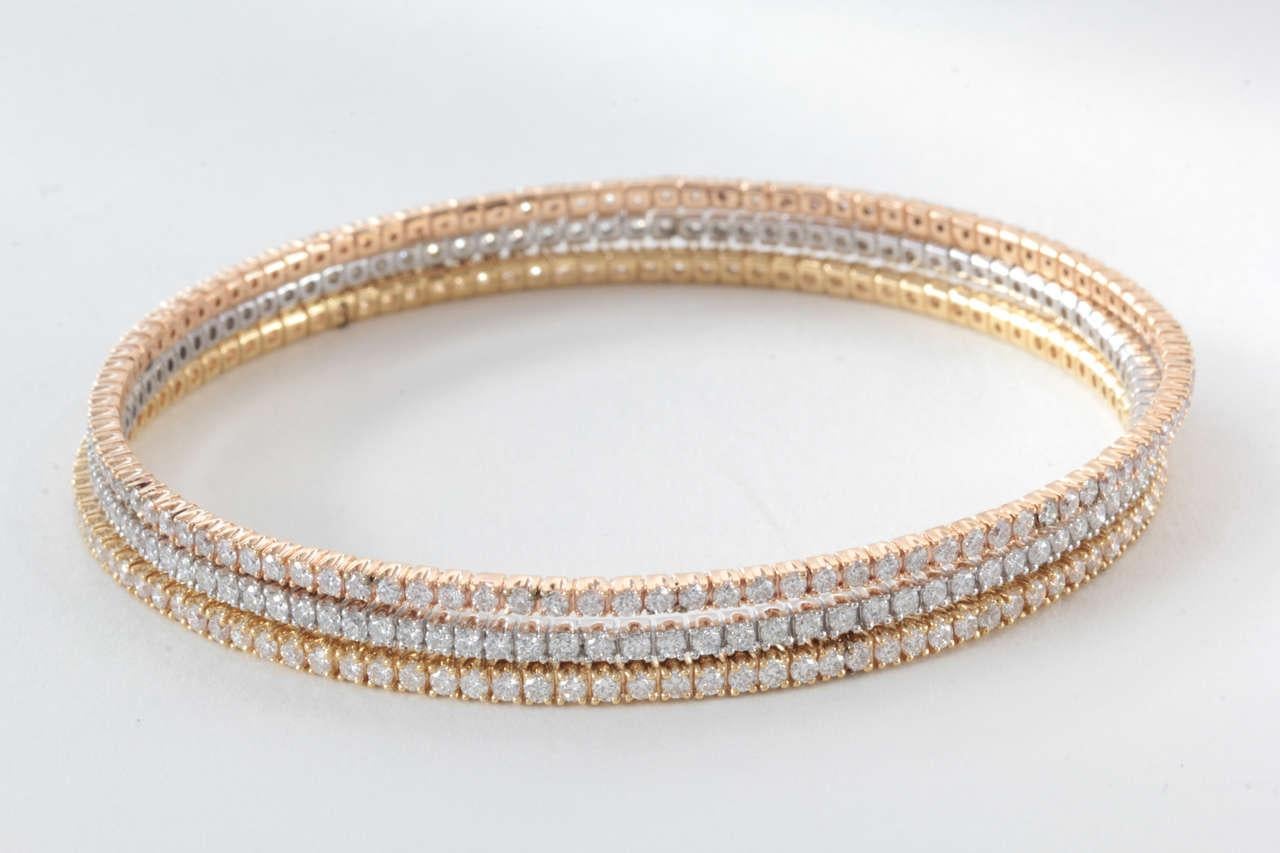 18k Rose, White and Yellow Gold Bangle Set with 357 round brilliant diamonds weighing 7.91 carats

8k White Gold 119 rounds 2.64 carats,10.84g
18k Yellow Gold 119 rounds 2.62 carats, 11.46g
18k Pink Gold 119 rounds 2.65 carats, 10.69g