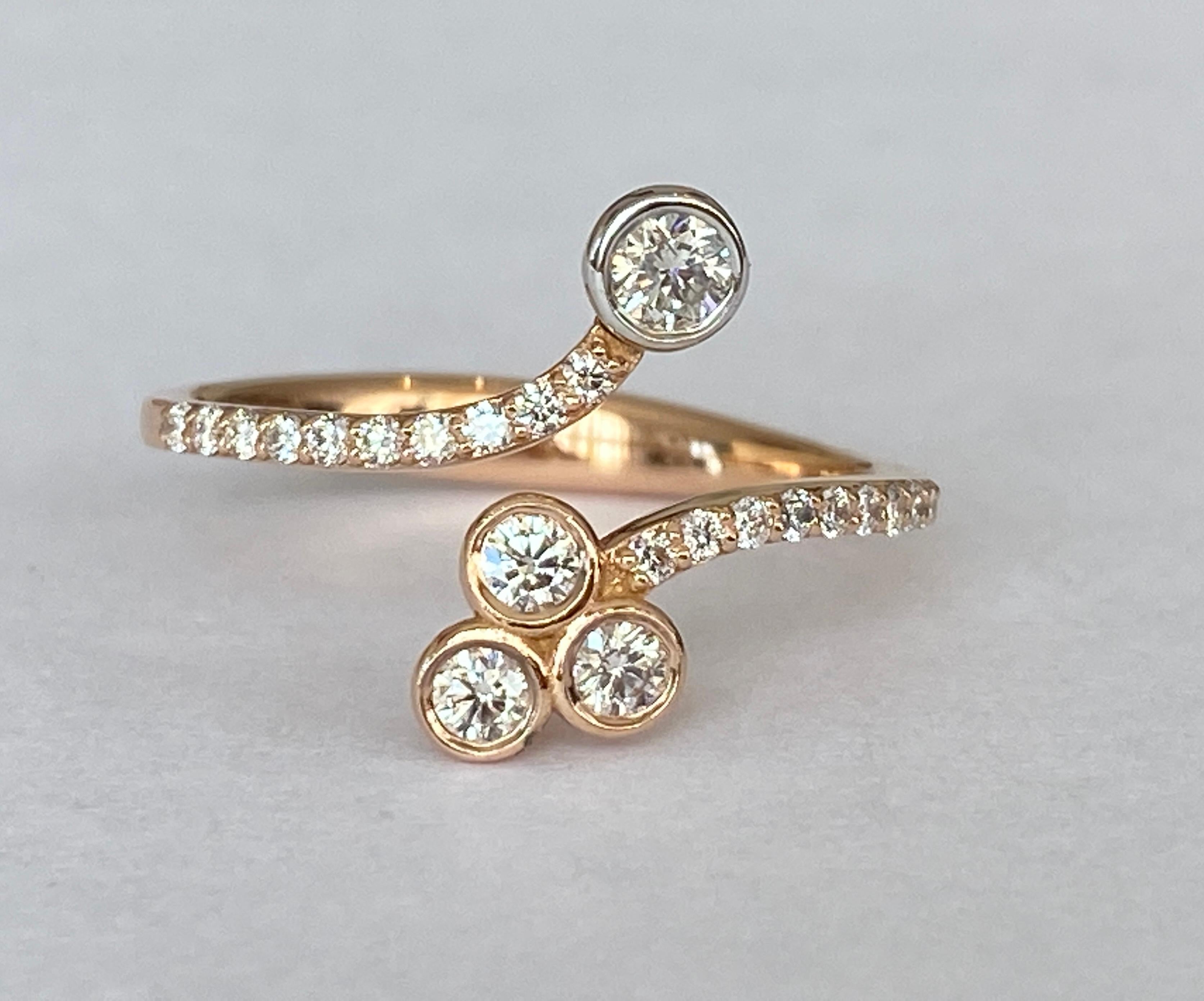 Offered 18 karat pink gold designer band ring. The ring is decorated with 23 brilliant cut diamonds in total approx. 0.45 ct quality G/VS/SI.
Content: 750 (approved)
Natural diamonds - approx. 0.45 ct
Weight: 2.6 grams
Ring size: 17.00 mm/ 6 ½ USA