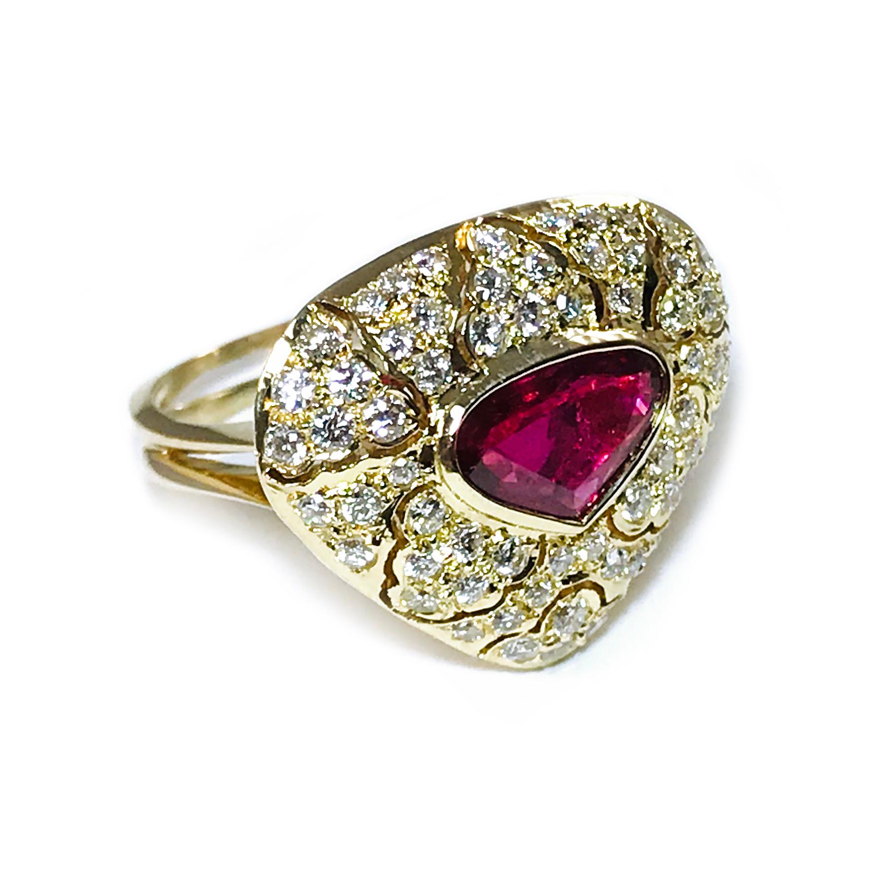 18 Karat Rubellite Tourmaline Diamond Ring. Faceted trillion Tourmaline measures 6.3 x 9.3 x 3mm for a weight of 1.10ct. Sixty-two round pavé-set diamonds surround the Tourmaline and create a rounded triangle-shaped dome. Diamonds are SI1-SI2 in