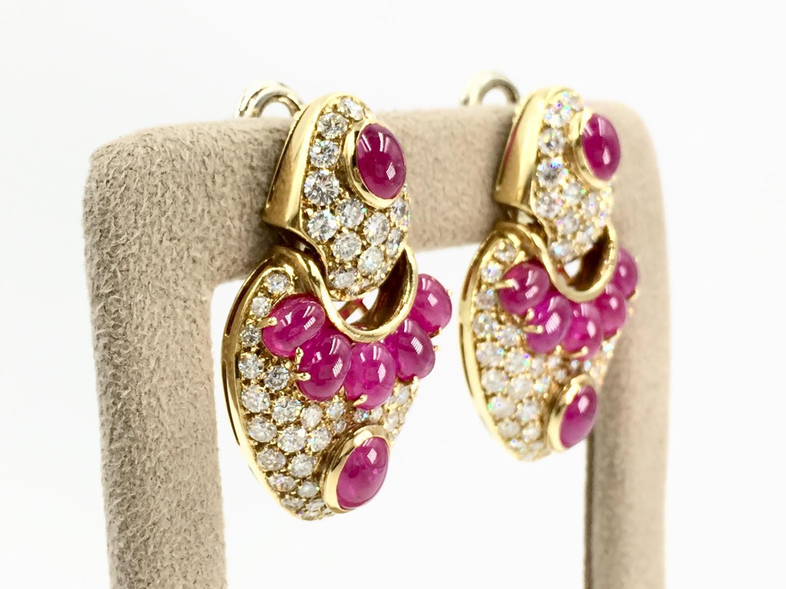 Gorgeous Italian made 18 karat drop earrings featuring 18.83 carats of vivid cabochon rubies and 5.87 carats of high quality white diamonds at approximately F color, VS2 clarity. Genuine rubies are rich in color with a purplish-red color and medium