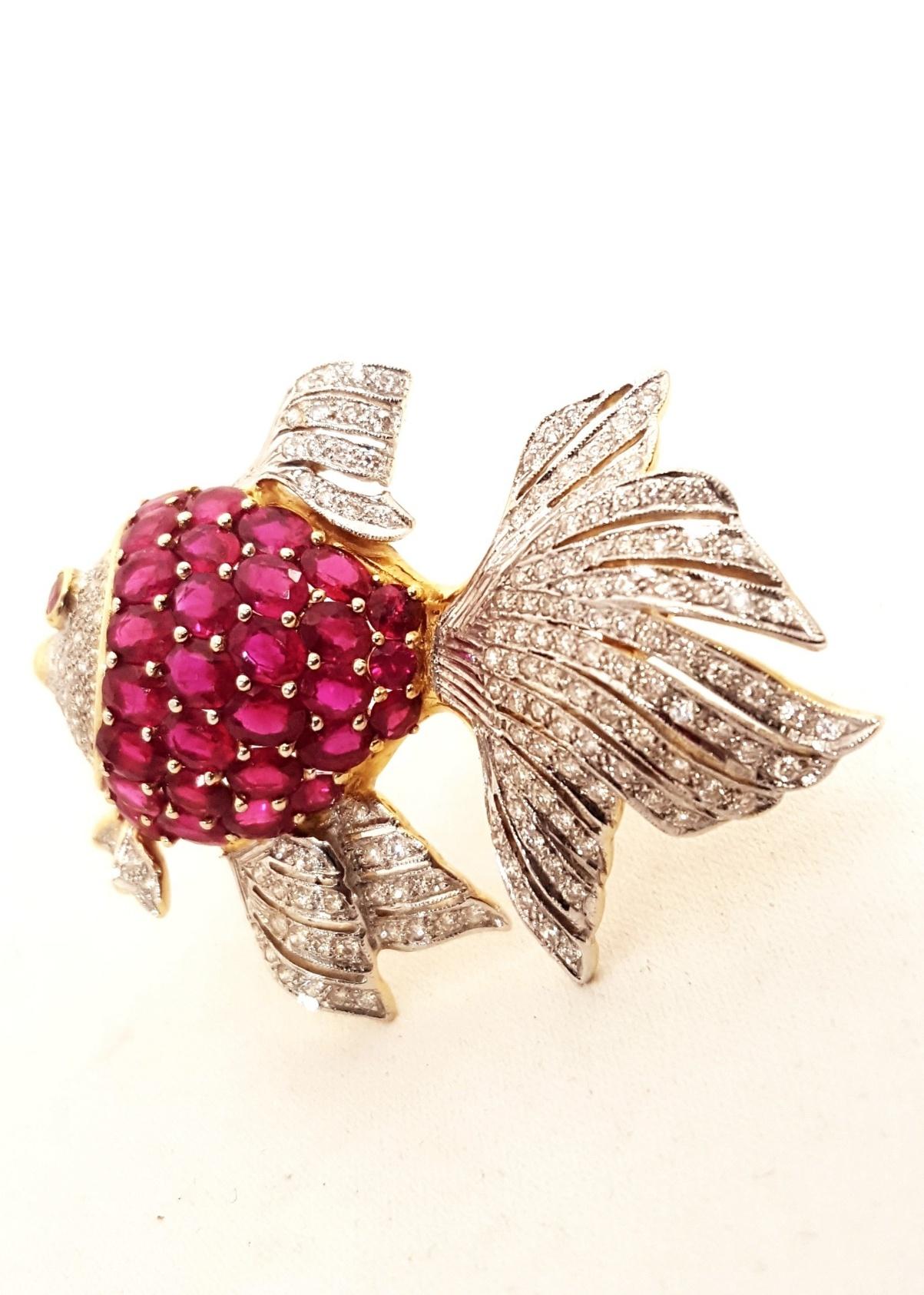 In 2006, this fabulous Fish sold at Neiman Marcus for $12000!  Not so today!  Fabricated in 18 karat yellow gold, this fan tail beauty boasts a body bursting with oval rubies with an approximate total weight of 6.00 carats.  A cabochon bezel set