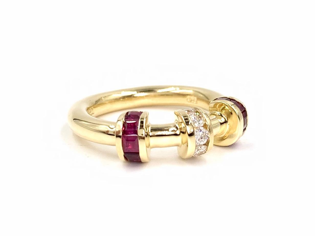 Created by expert fine jeweler, Charles Krypell. This solid 18 karat yellow gold modern band style ring features .73 carats of vivid, well saturated rubies and .20 carats of bright white round brilliant diamonds arranged in bar style channels.