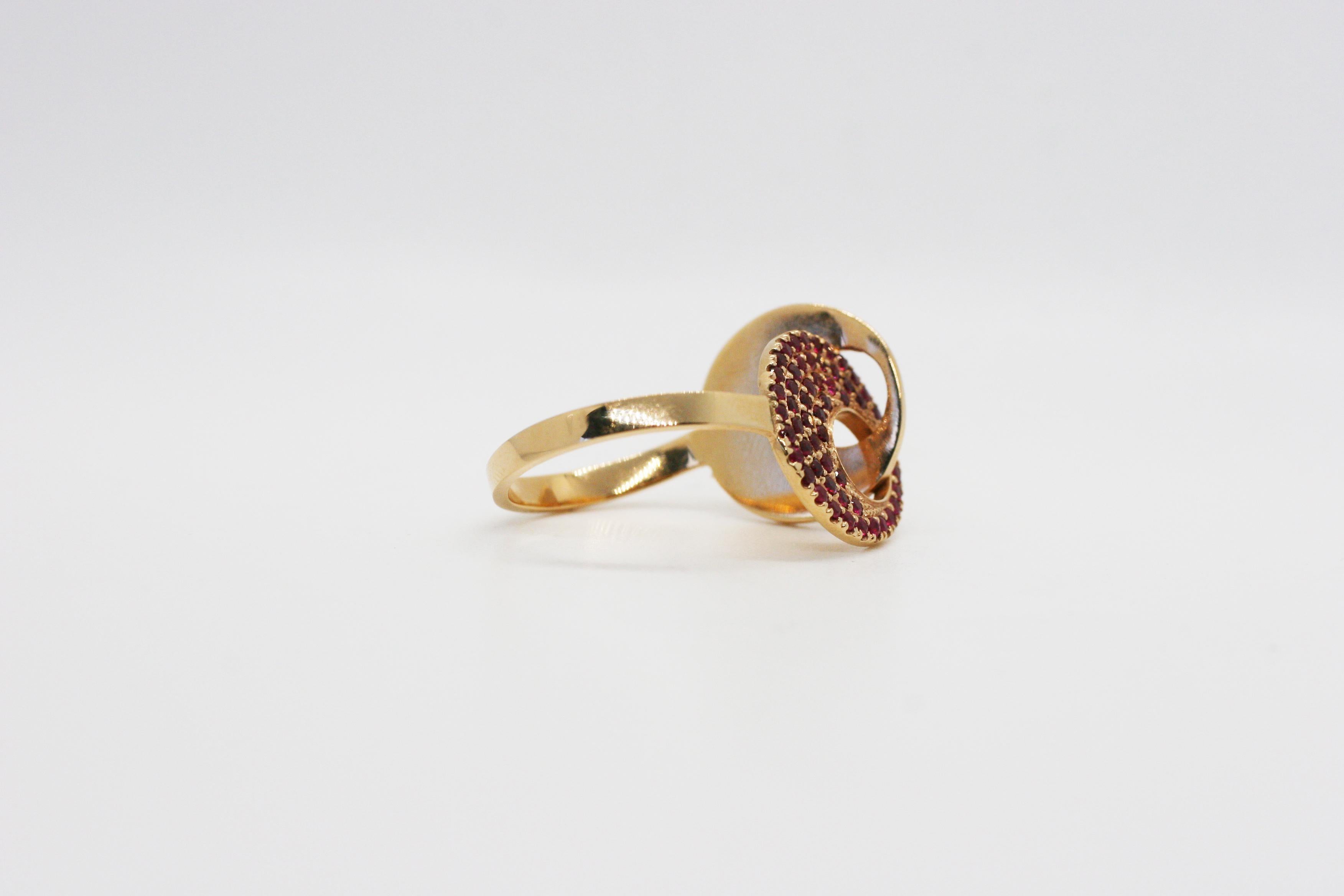 Perez Bitan's Interlocking Circles Ring features a solid 18k rose gold band with one architectural Rose Gold circle interlocking with a Rose Gold circle with 55 pave set rubies 
Band can be resized 

