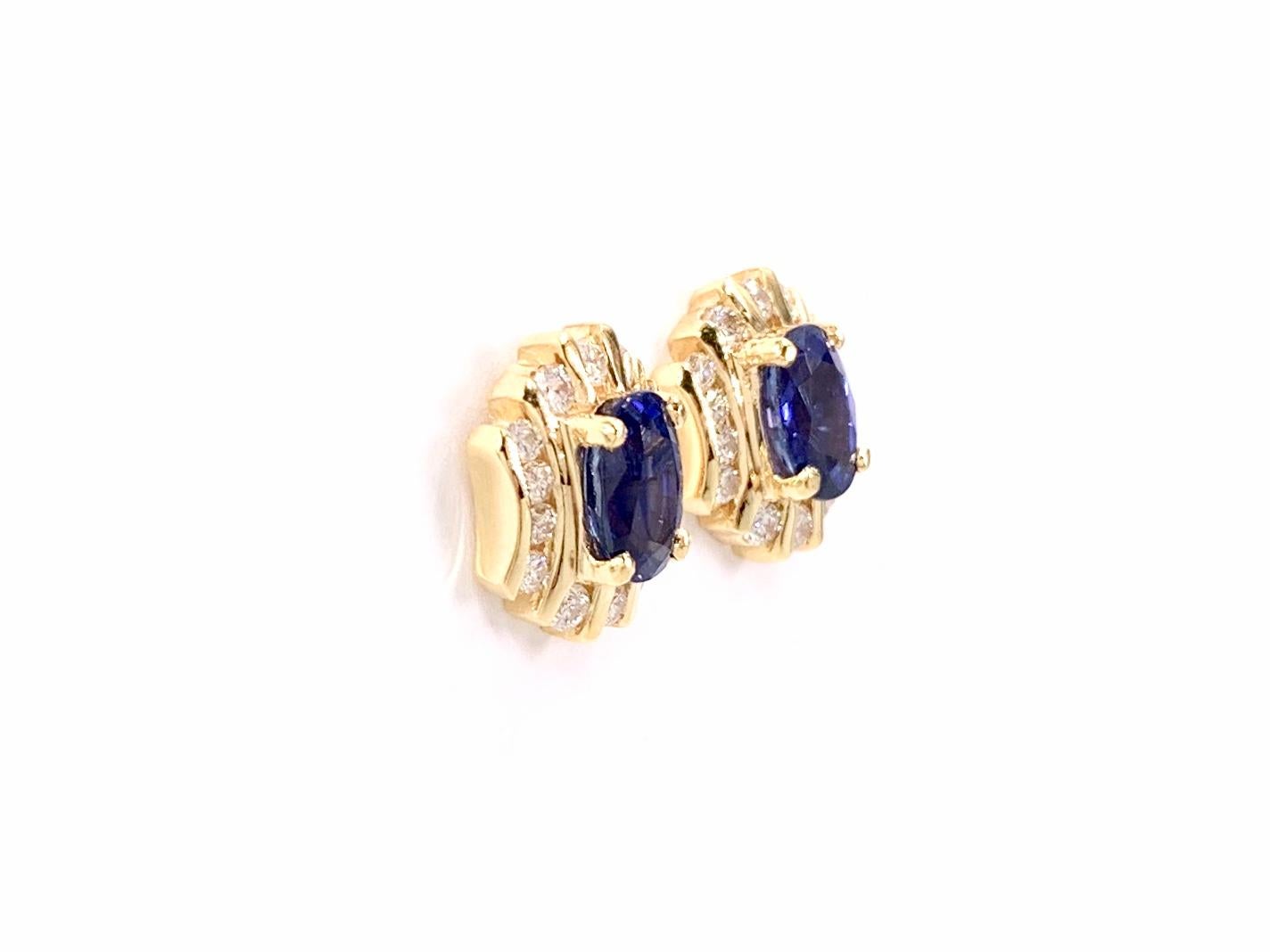 Beautiful every-day button stud earrings made with 18 karat yellow gold featuring two high quality oval blue sapphires at 1.89 carats total weight. Sapphires have excellent clarity with a rich, royal blue hue and medium transparency - not at all
