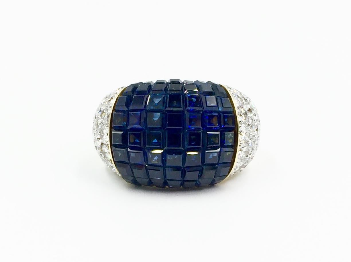 A unique and beautiful sapphire and diamond 18 karat cocktail ring made with superior quality and craftsmanship. Ring features 13.09 carats of rich square blue sapphires, perfectly invisibly set. 1.82 carats of high quality round brilliant pavé set