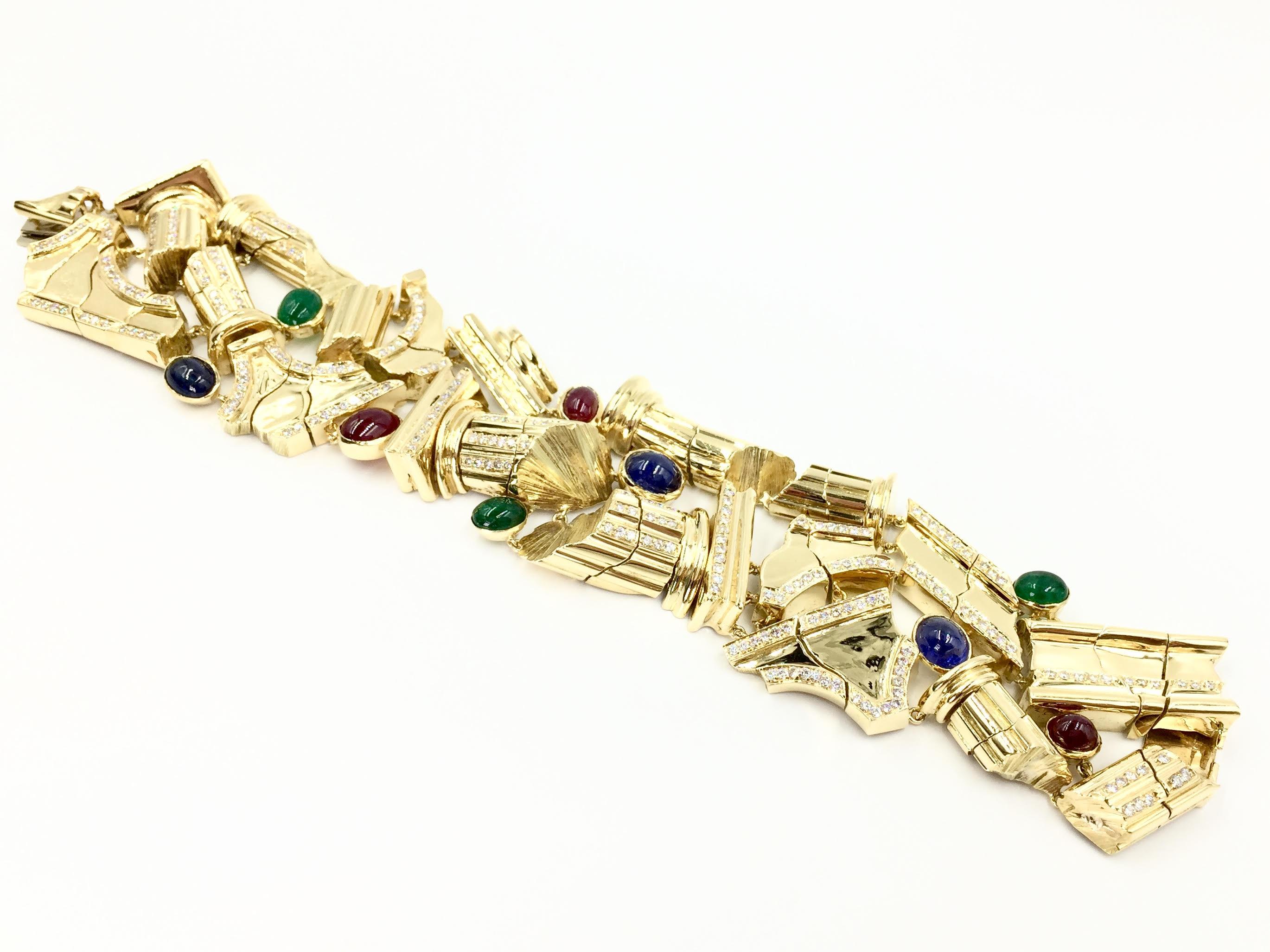 A truly unique find. This heavy and substantial 18 karat yellow gold Roman design link design bracelet features high quality and expertly polished cabochon blue sapphires, rubies and emeralds. 3.43 carats of bright white diamonds add extra sparkle