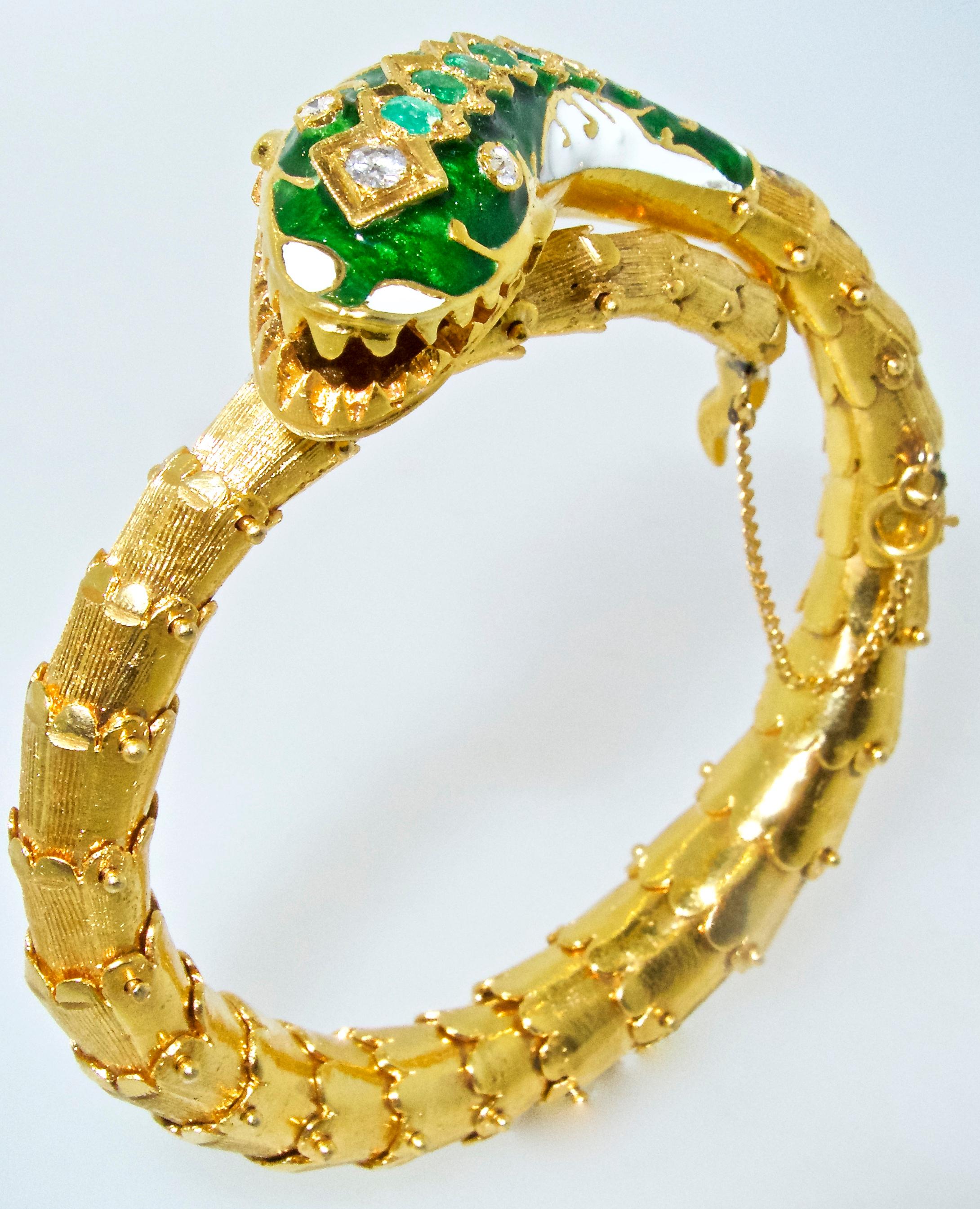 18K yellow gold serpent or snake bracelet adorned with emeralds and diamonds.   His scales are articulated, his head is green and white enamel.  Our happy serpent weighs 62.88 grams and has an interior dimension of 6.25 inches.  In Victorian