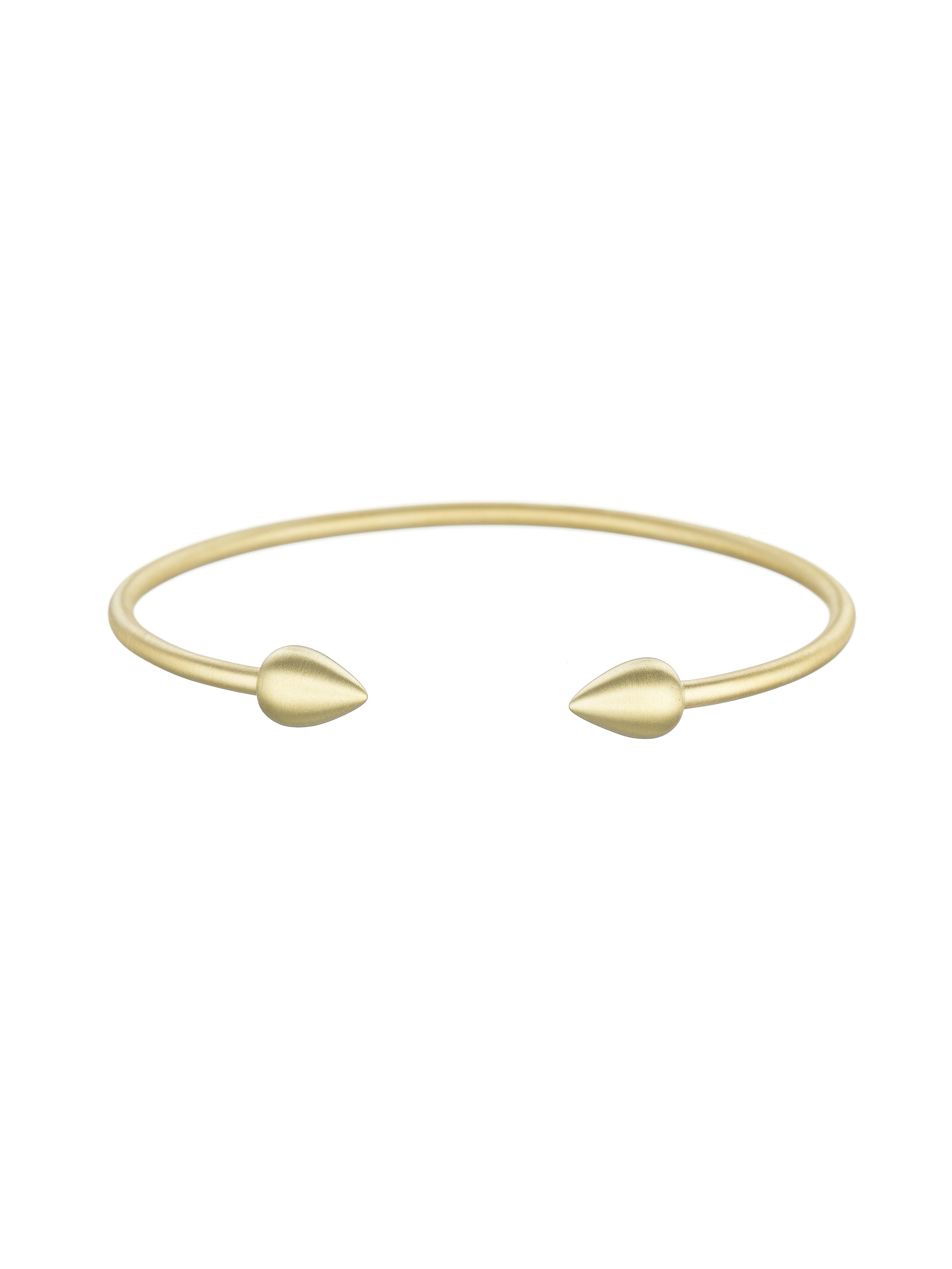 A simple 18 karat gold bangle that will become a such a part of your collection you'll feel naked without it. Available in high polish or satin finish. 