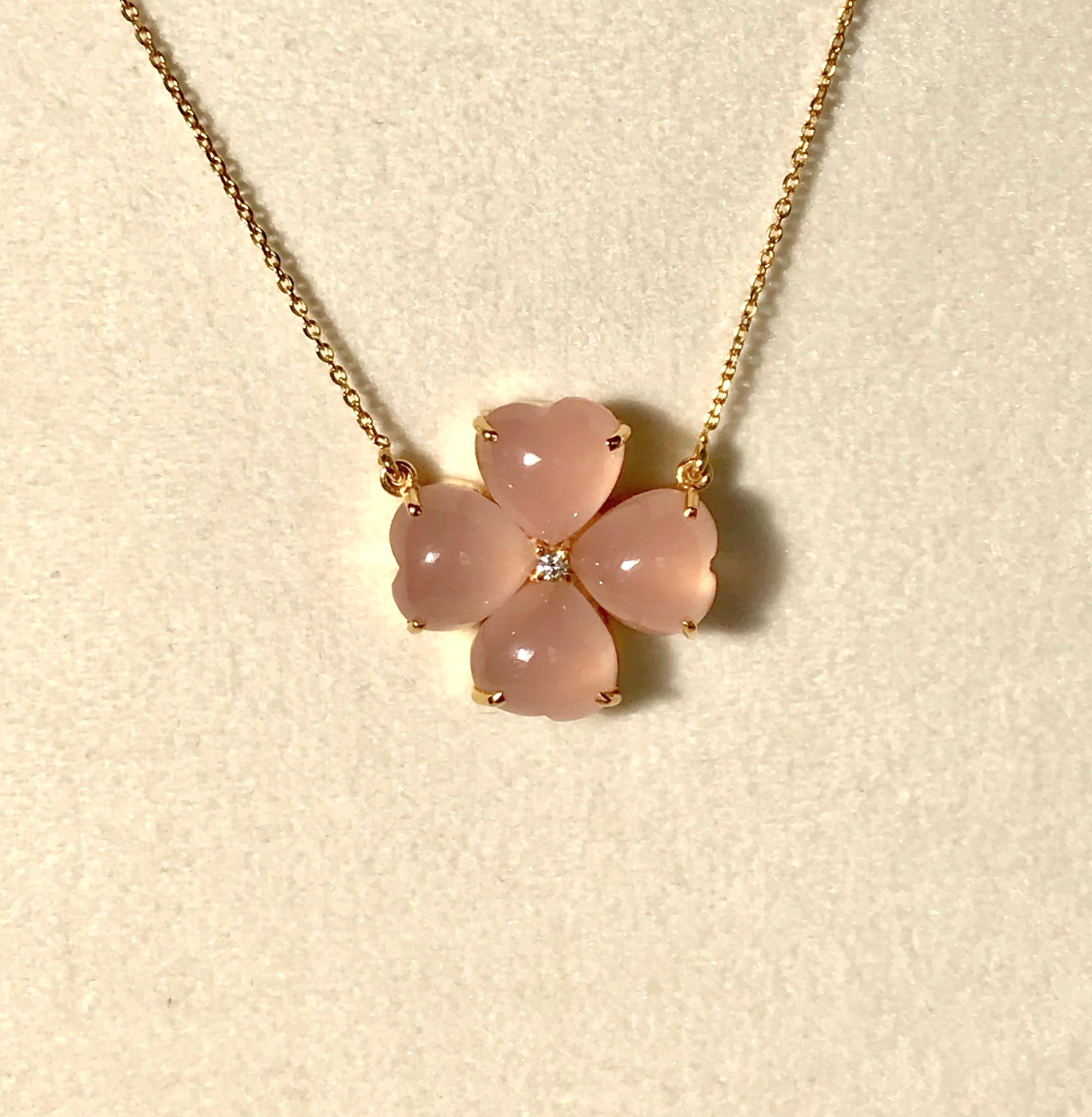 Handmade necklace in 18 Karat solid yellow gold, 4 pink chalcedony stones and a diamond centre. 
Four leaves clover is a symbol of good luck and happiness.  Those who find a four-leaf clover are destined for good luck, as each leaf in the clover