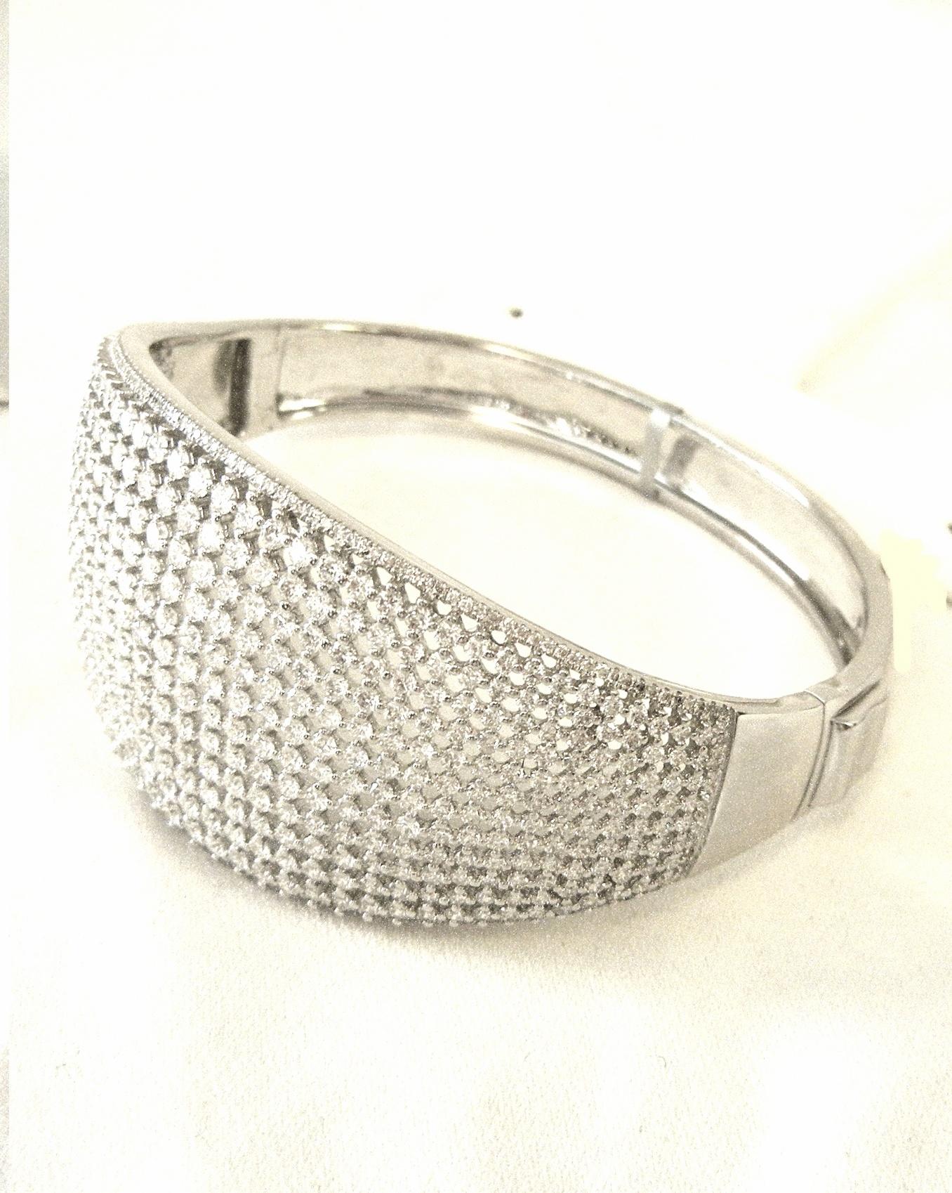 Brand New!  An exquisite 18 karat white gold wide tapered cuff boasting twelve shared prong white diamonds.  Accenting the twelve rows are micro pave white diamonds on each end and side.  Sparkle is fabulous!  An impressive count of 195 round white