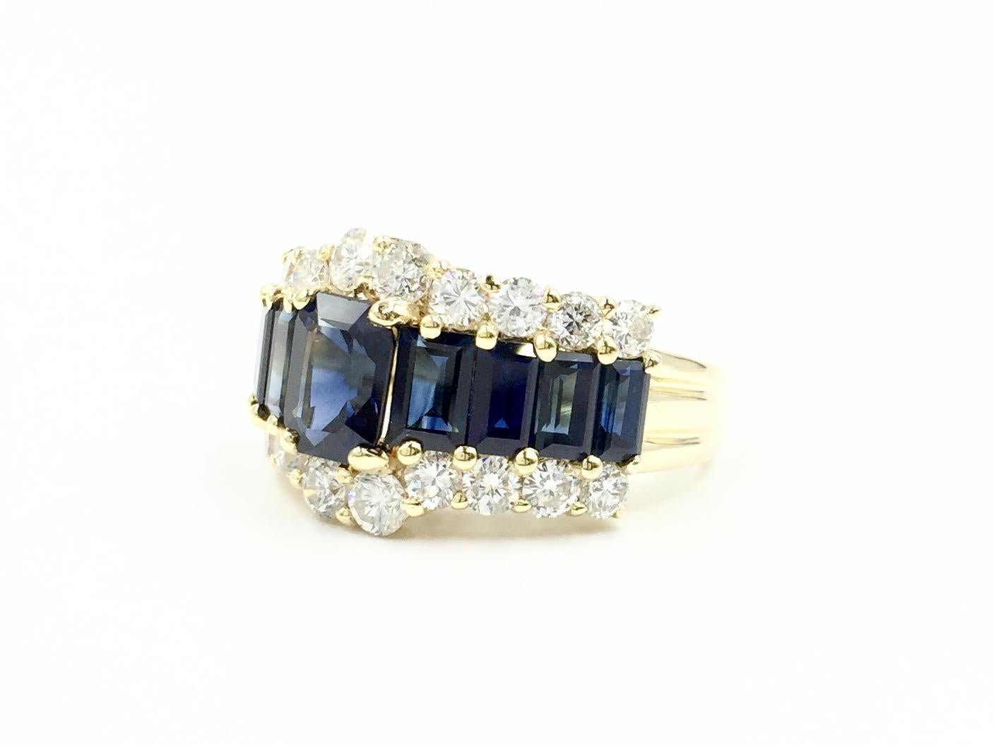 An incredibly beautiful ring with a classic design and high quality stones. This 18 karat gold ring features 5.09 carats of rich royal blue emerald cut sapphires and 1.47 carats of bright round brilliant diamonds. Diamond quality is approximately F