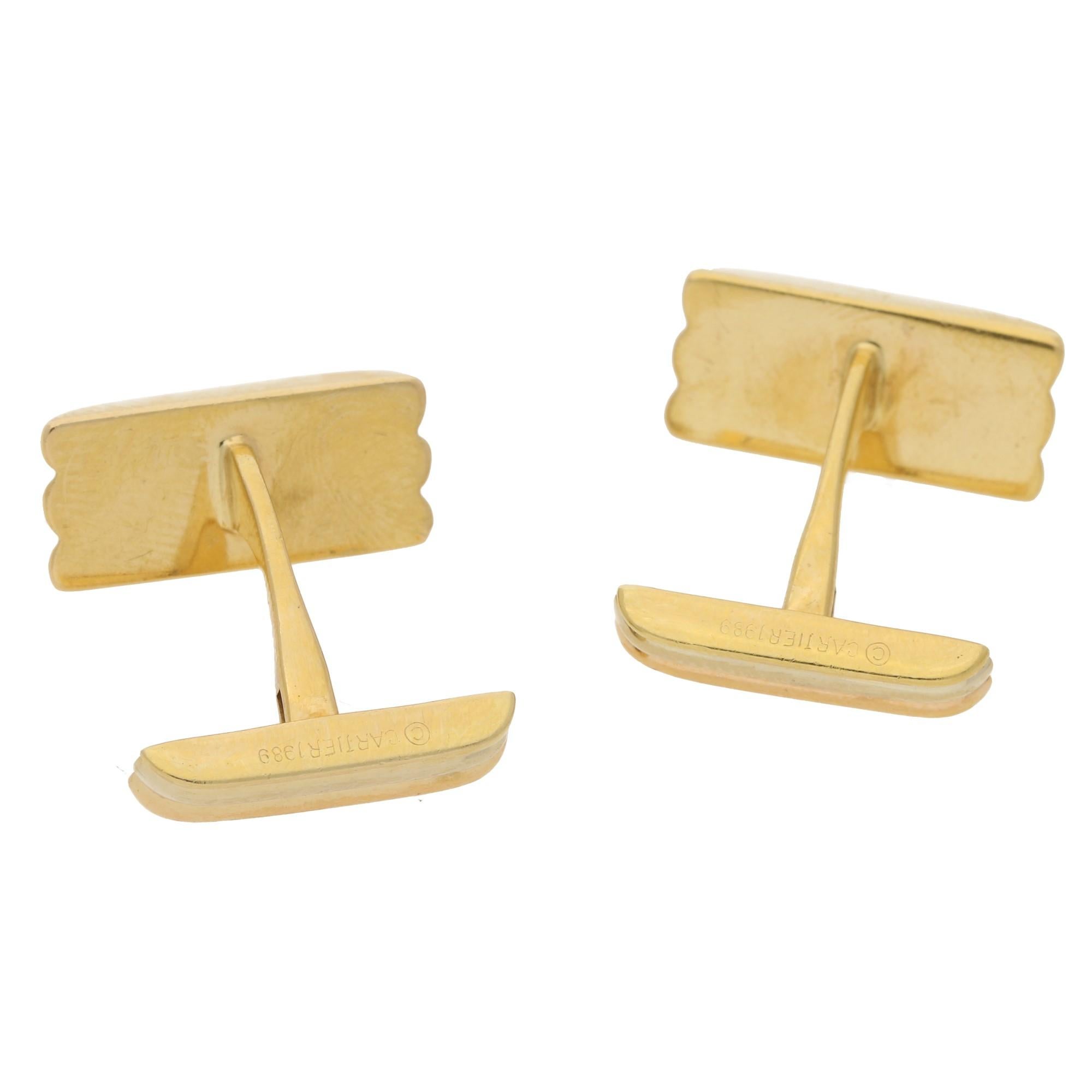 An elegant pair of Cartier signed 18ct yellow, white and rose gold ridged bar cufflinks. With a bar and sprung panel fitting. 
