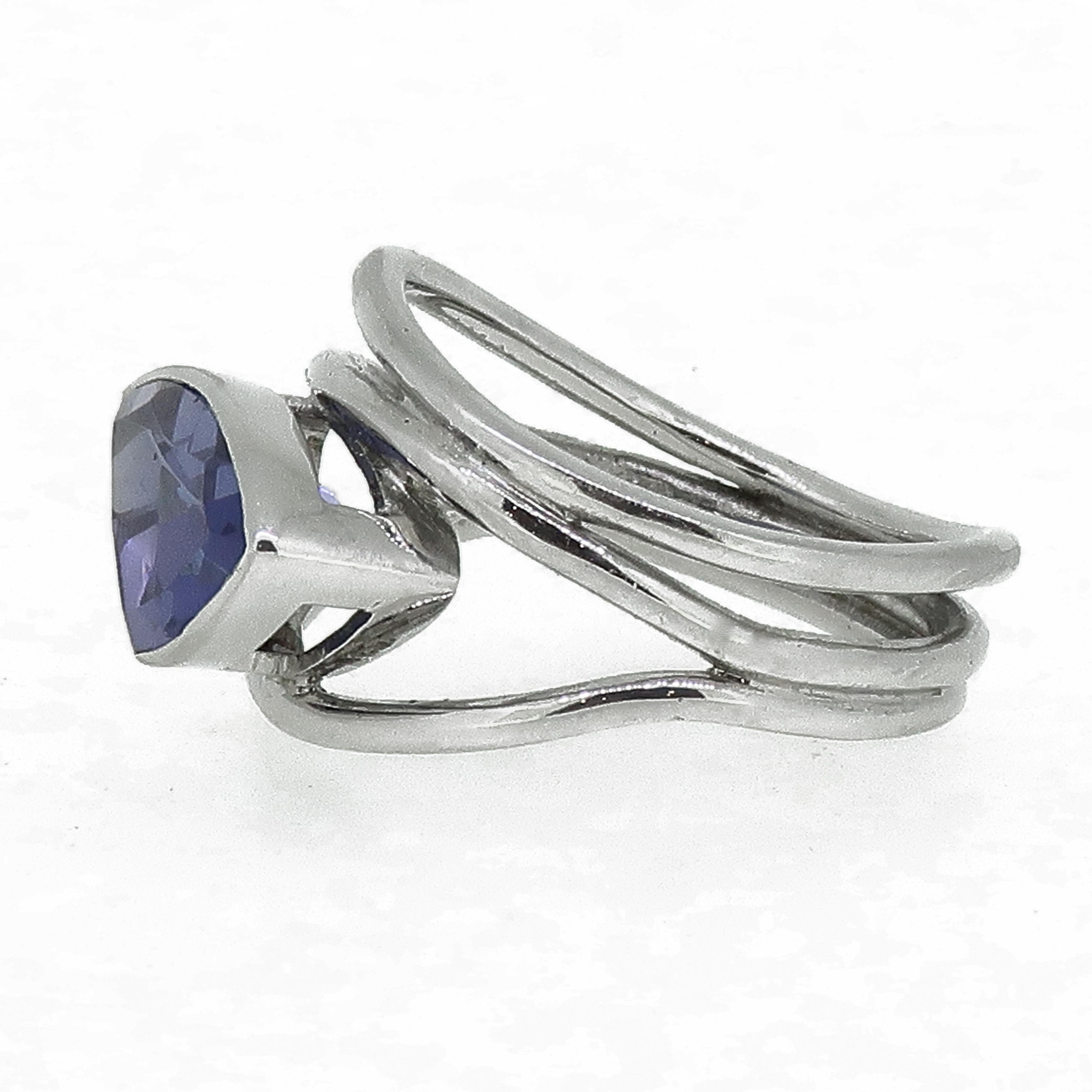 18 Karat Trillion Tanzanite Solitaire Ring White Gold

A abstract trillion tanzanite ring. Trillion tanzanite that measures 13mm x 8mm and stands proud on the finger. The fabulous stone is set in a rub over setting in between three bands of gold in