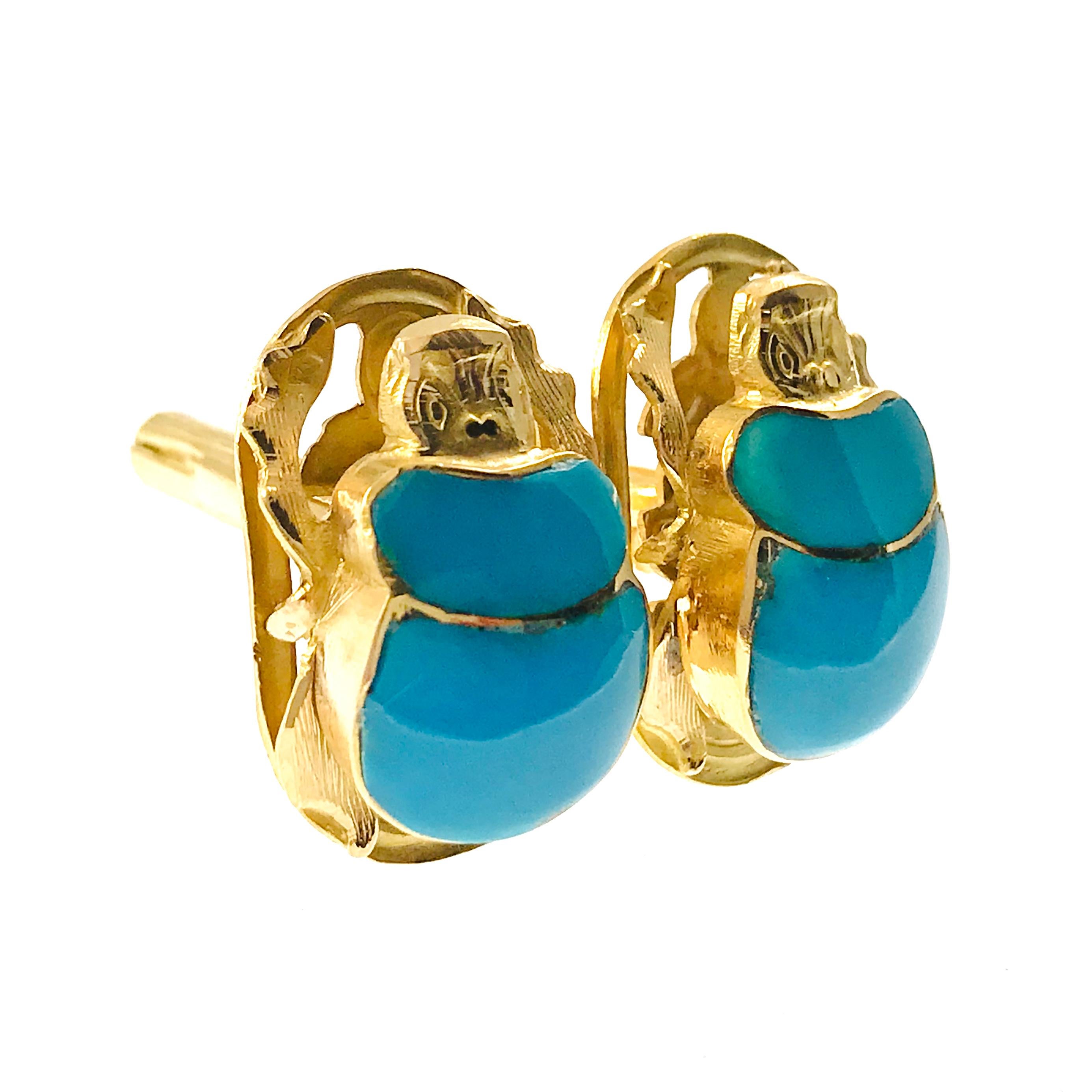 18 Karat Turquoise Scarab Egyptian Cufflinks. The fronts feature a gold scarab beetle with two pieces of blue-green turquoise as the body. The cufflinks have a detailed back, a dual post, and torpedo toggle. The cufflink measure approximately 24mm x