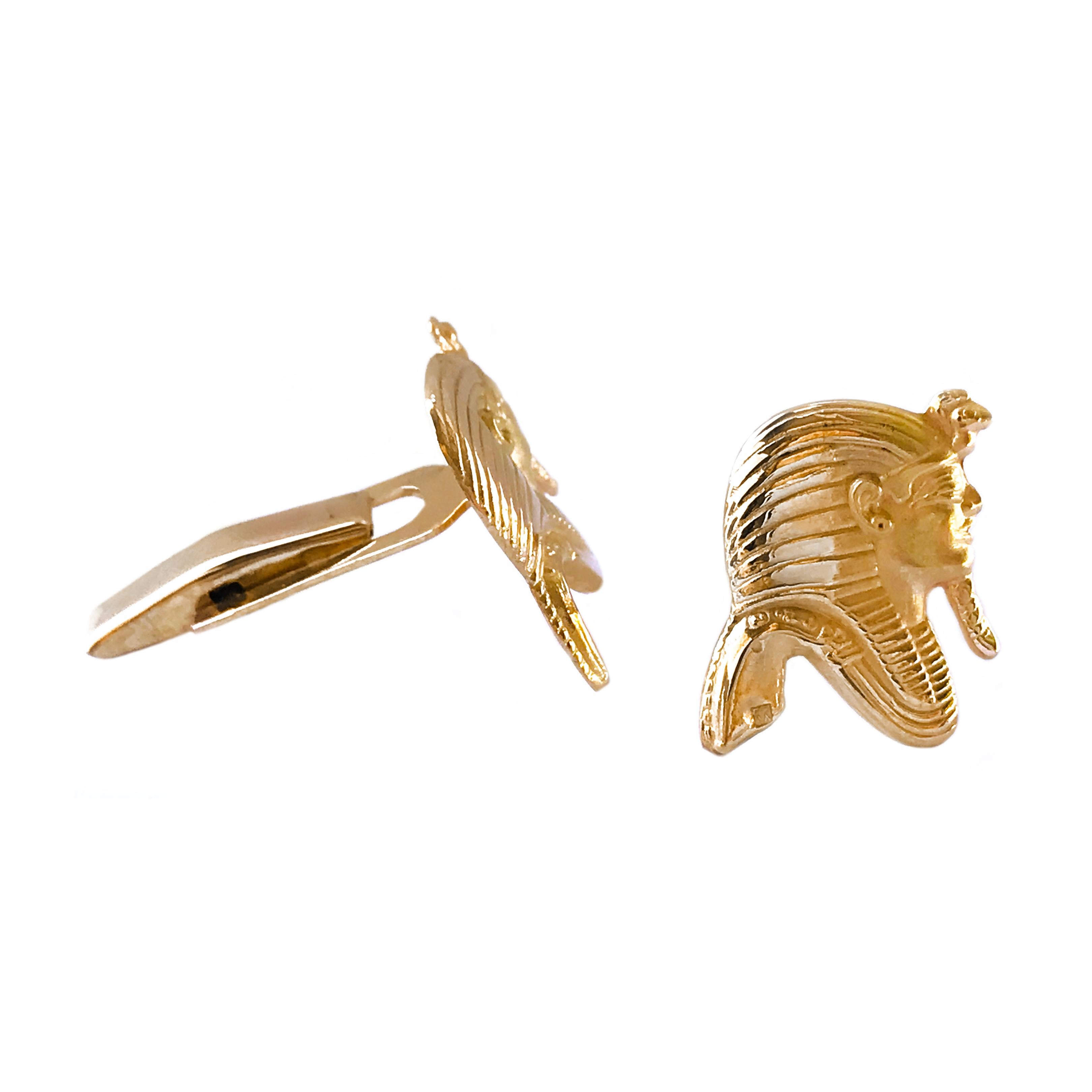 18 Karat tested Tutankhamun Egyptian Pharaoh Cufflinks. The fronts feature the infamous boy king's golden mask in profile with meticulous detail. The cufflinks have a smooth back, a dual post, and whale tail toggle backings. The cufflink measure