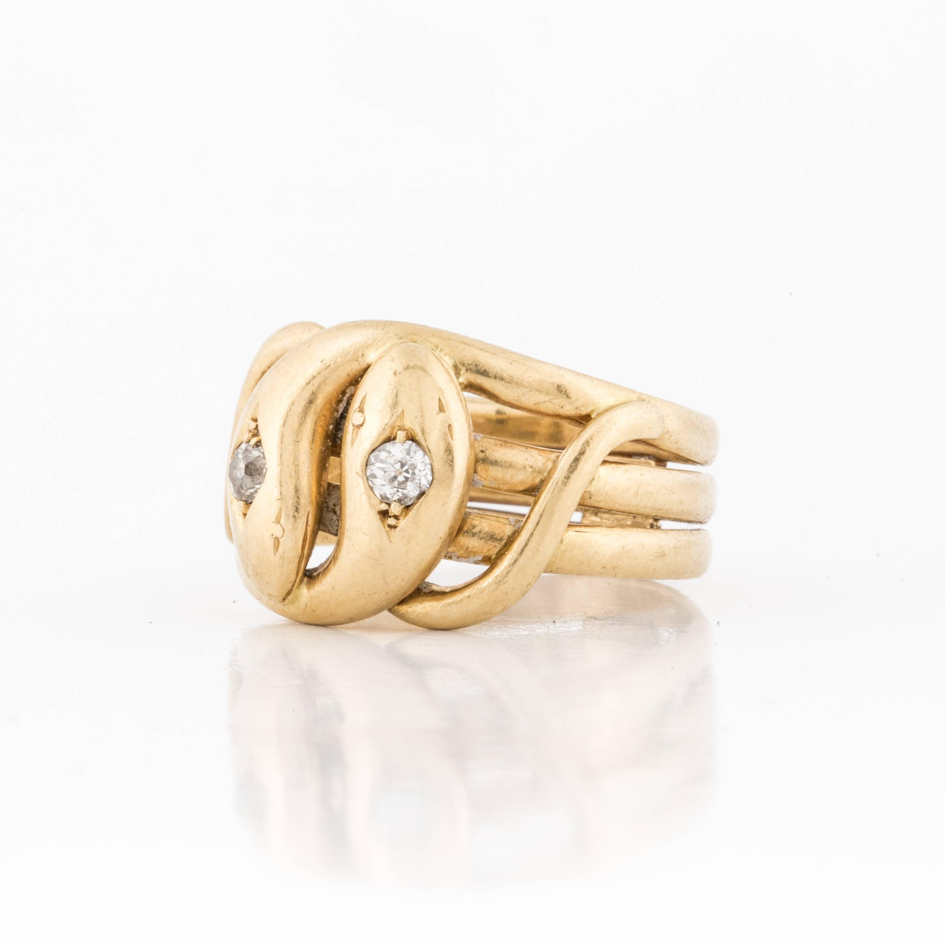 Ring featuring two intertwining serpents in 18K yellow gold.  Each serpents head is set with an old mine-cut diamond that total 0.25 carats, G-J in color and SI clarity.  Ring is currently a size 9 1/2.  Presentation area is 3/4 inches by 1/2 inches.