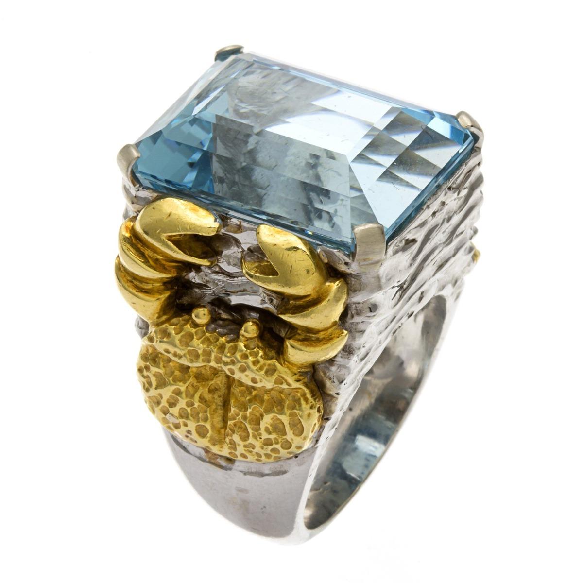 Metal: 18 K Two-Tone Gold 
Finger Size: 7
Gram Weight: 32.3 Gms
Diamond Carat Weight: N/A
Diamond color: N/A
Diamond Clarity: N/A
Diamond Cut: N/A
Gemstone: Aquamarine
Gemstone Weight: 25 CT
Gemstone Cut: Emerald
Gemstone Color: Aqua